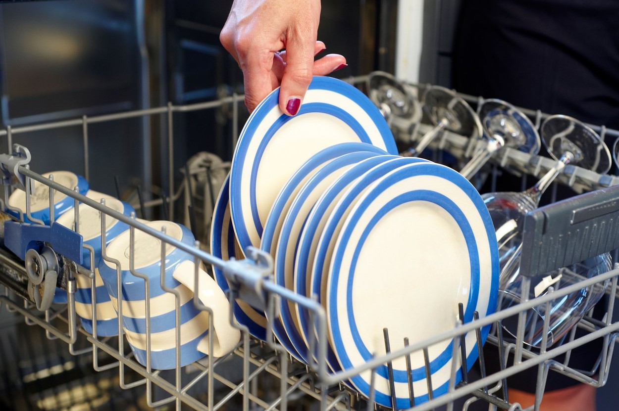 Dishwasher being filled, detail