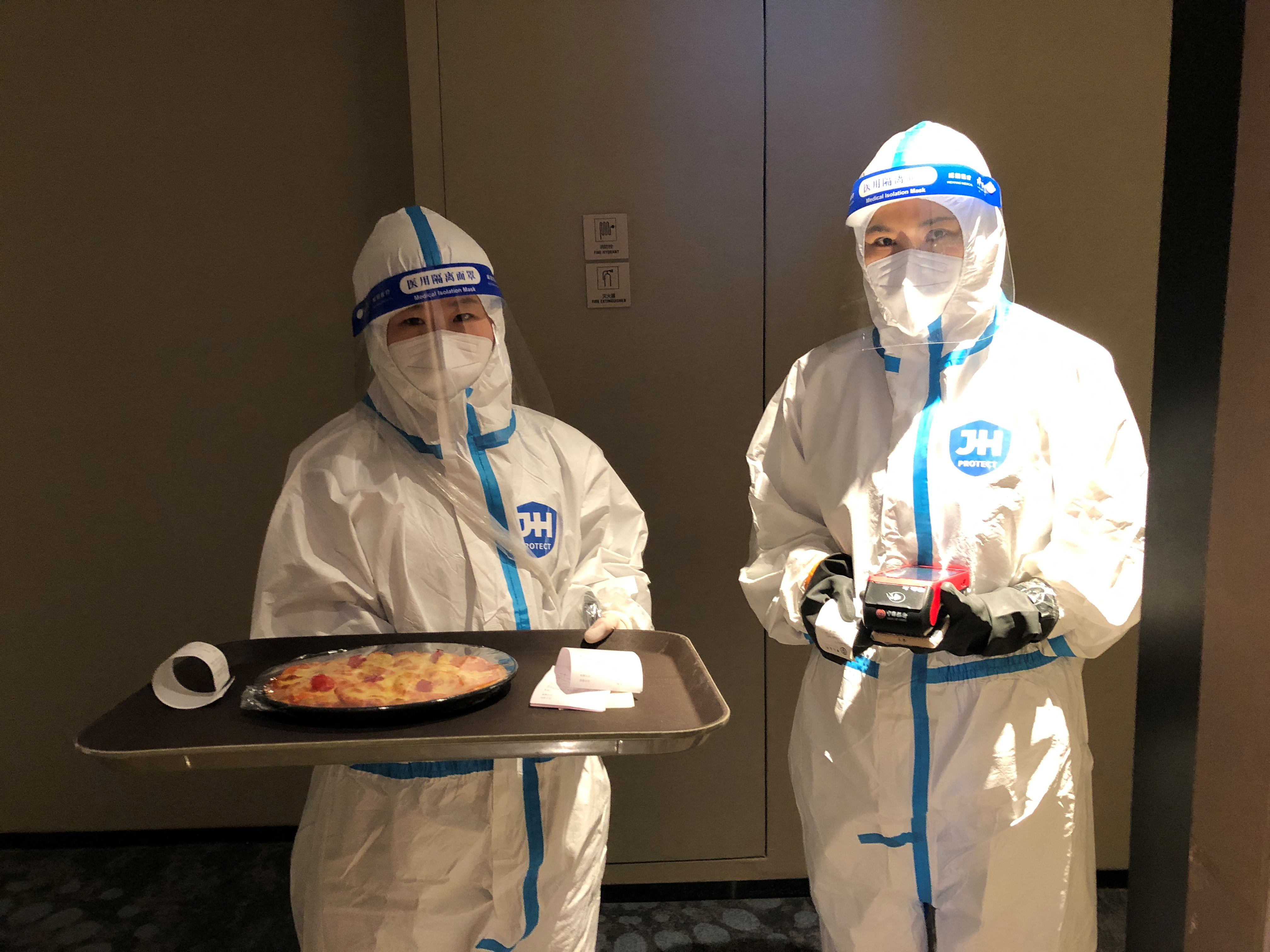 Cocktails and hazmat suits mingle in the Beijing Olympics bubble