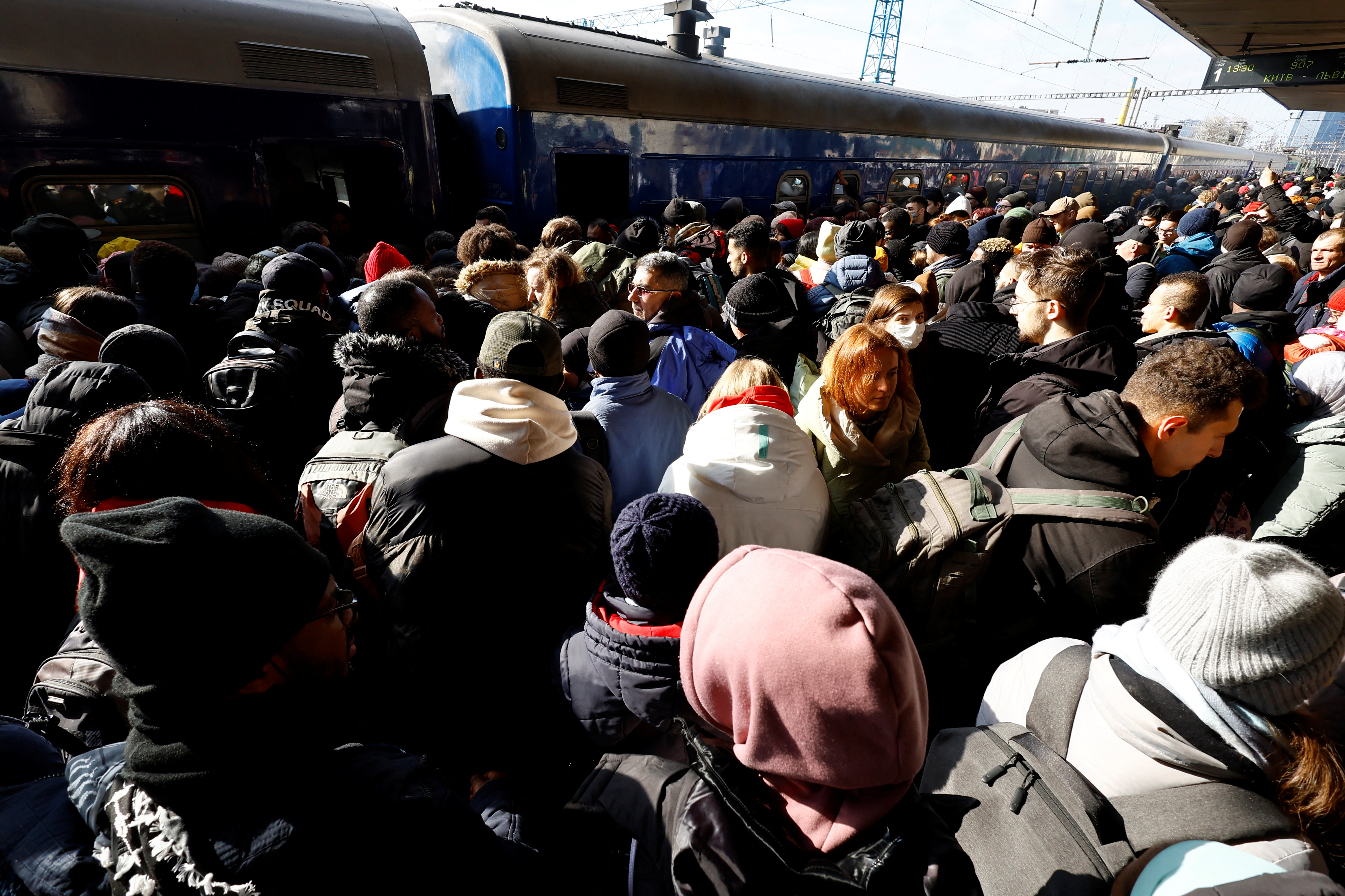 People wait to board an evacuaition train from Kyiv to Lviv at Kyiv central train station