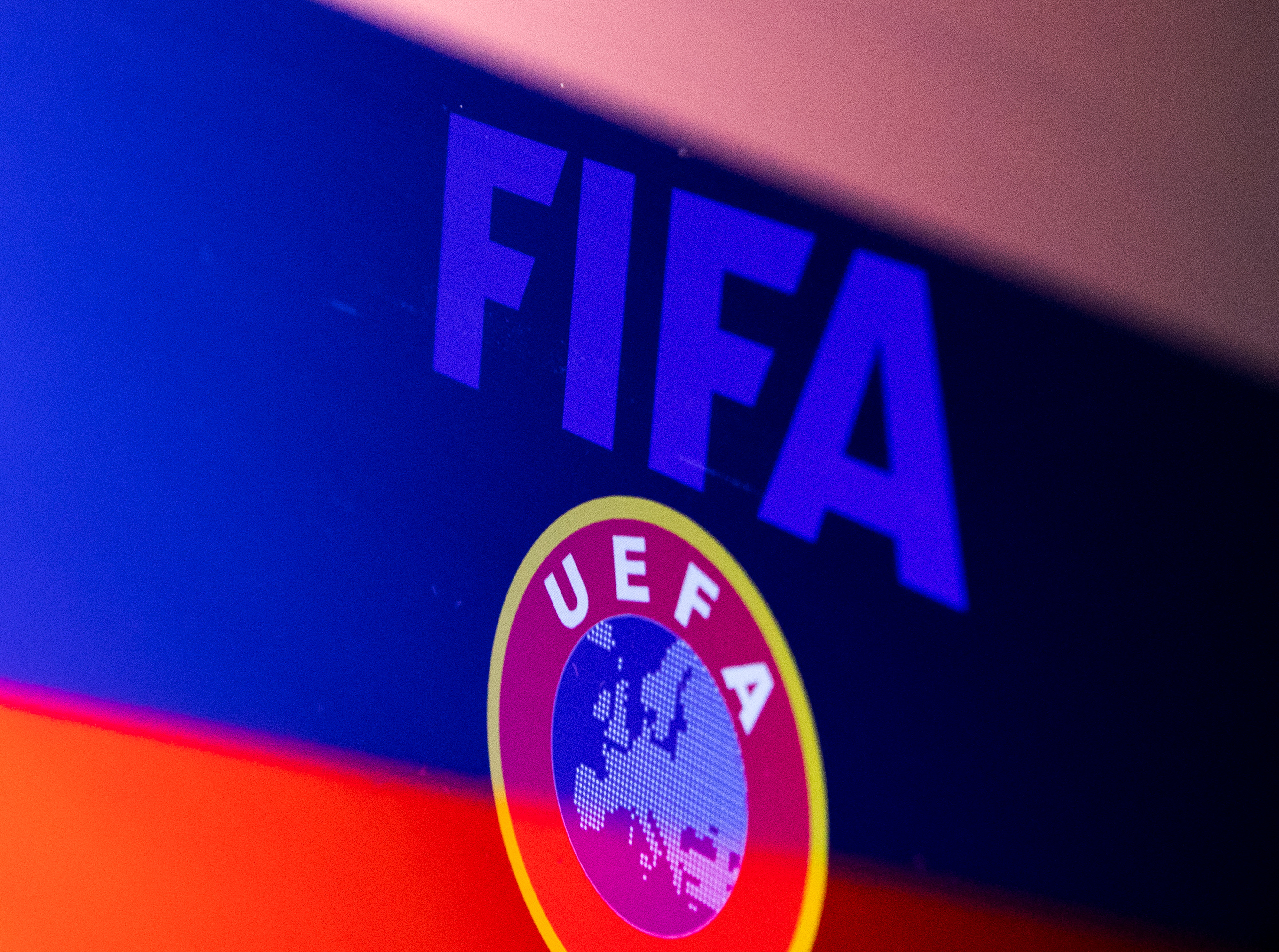Illustration shows FIFA and UEFA logos and Russian flag