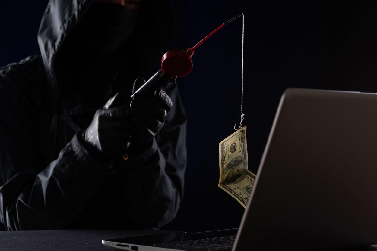 Internet fraud using computer technology, stealing money on the Internet, stealing credit card data. Hacker caught a dollar bill of money on the bait.