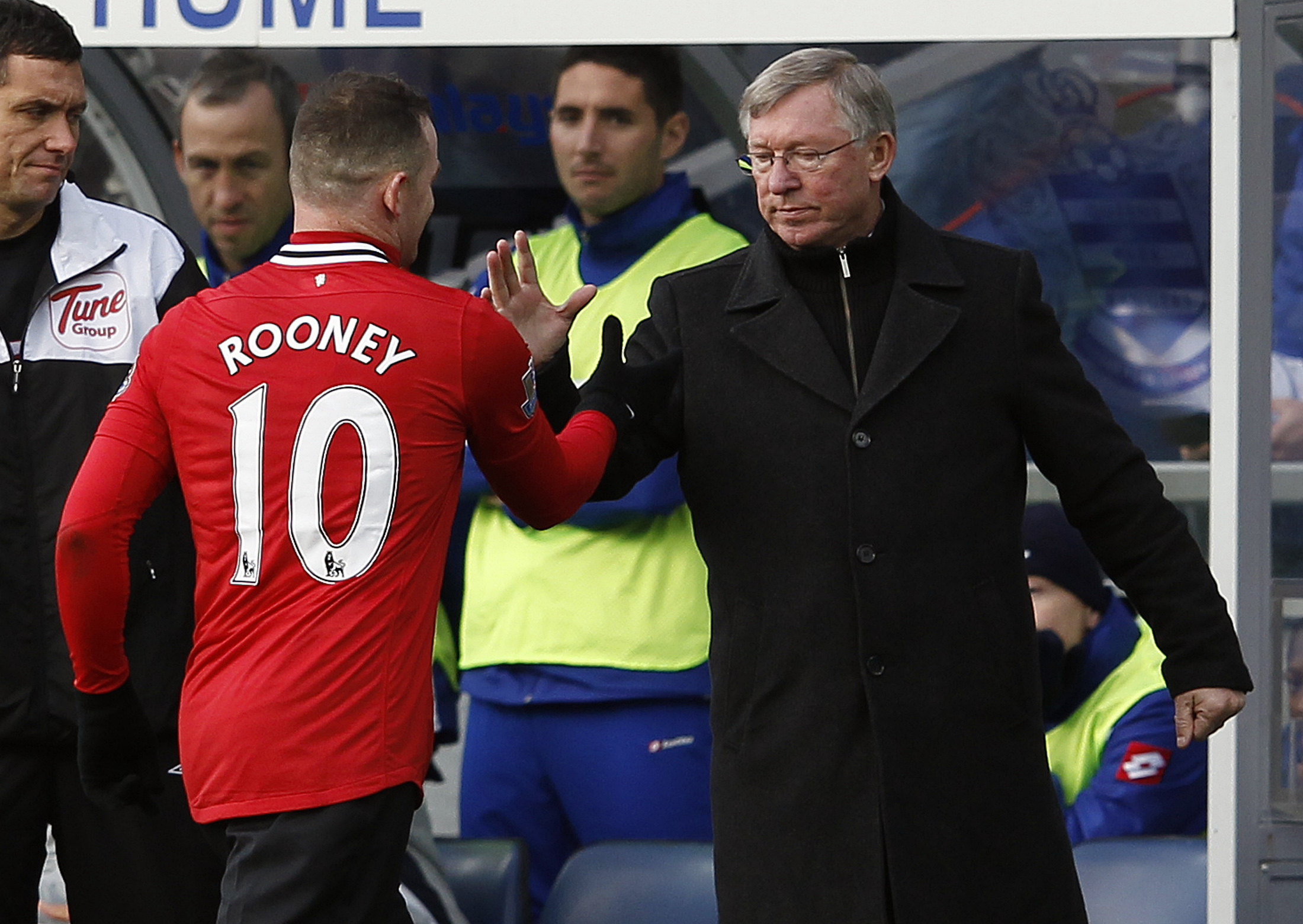 Manchester United manager Ferguson shakes hands with Rooney as he is substituted against Queens Park Rangers in London