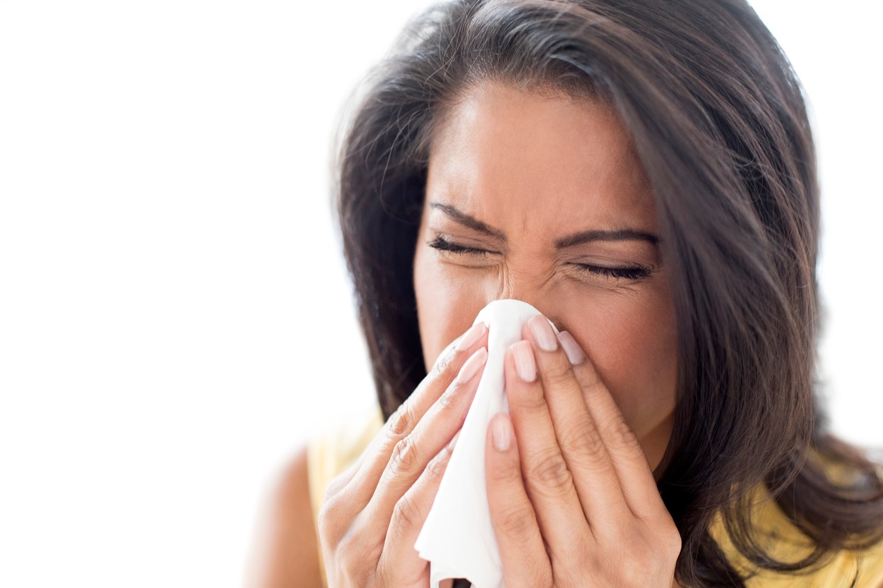 Woman sneezing
