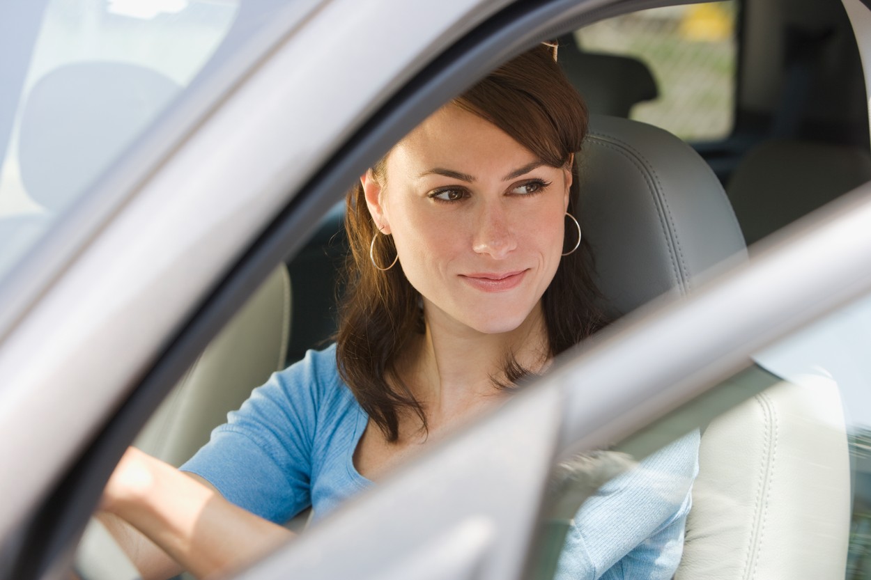 Young woman in driver’s side of car