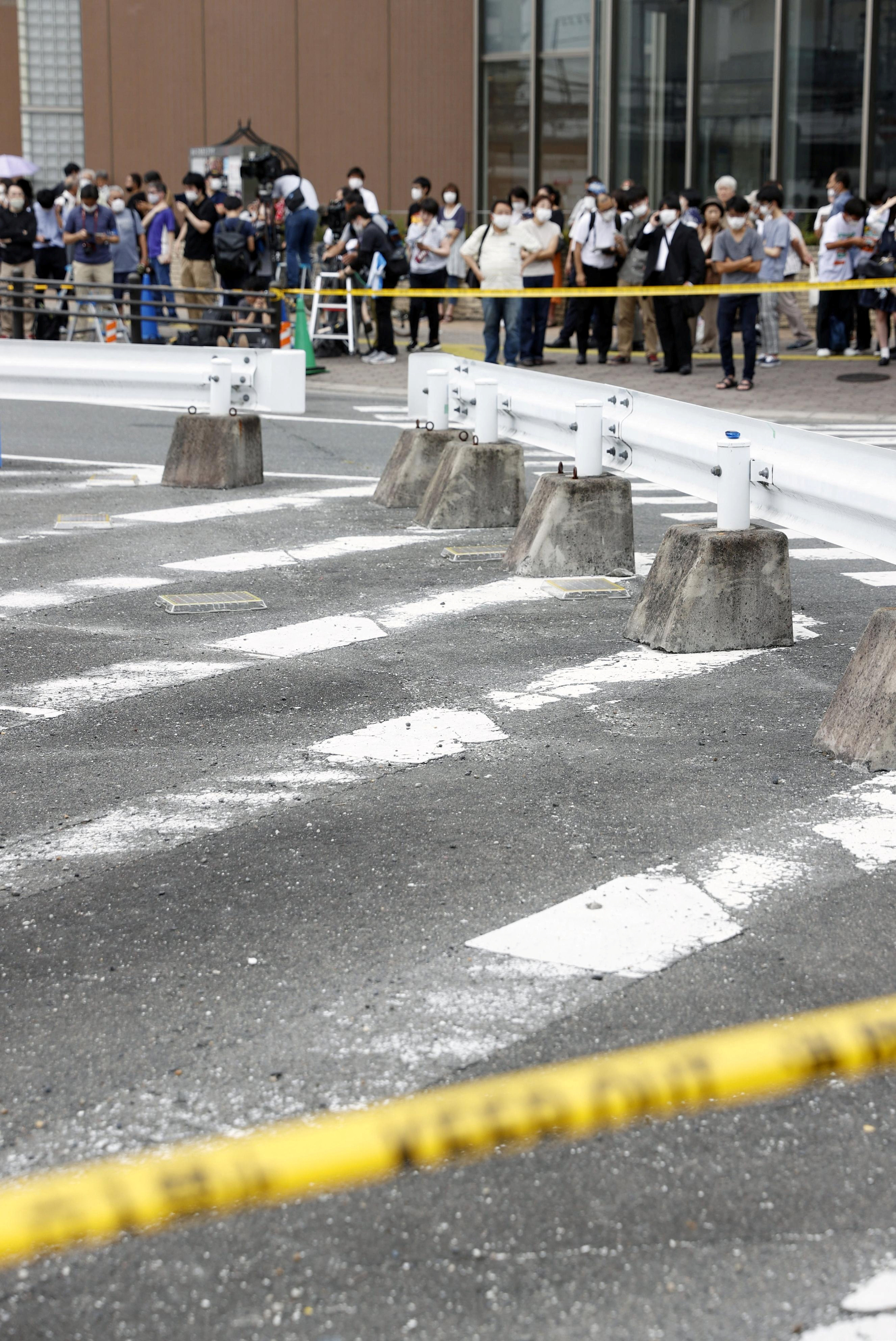 Investigators work around the scene where former Japanese Prime Minister Shinzo Abe was shot from behind by a man in Nara