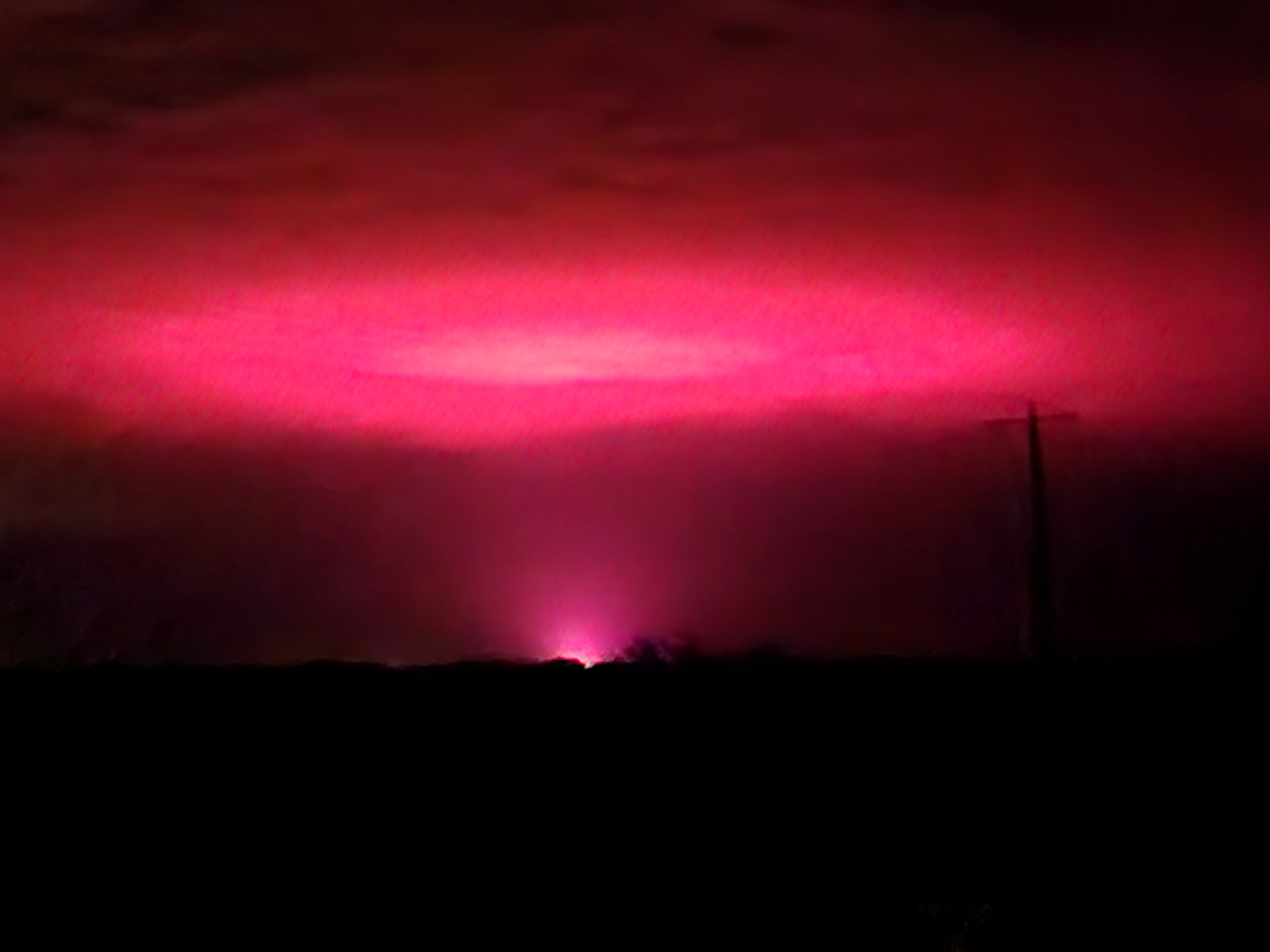 Pink glow lights up the sky above of Australian town