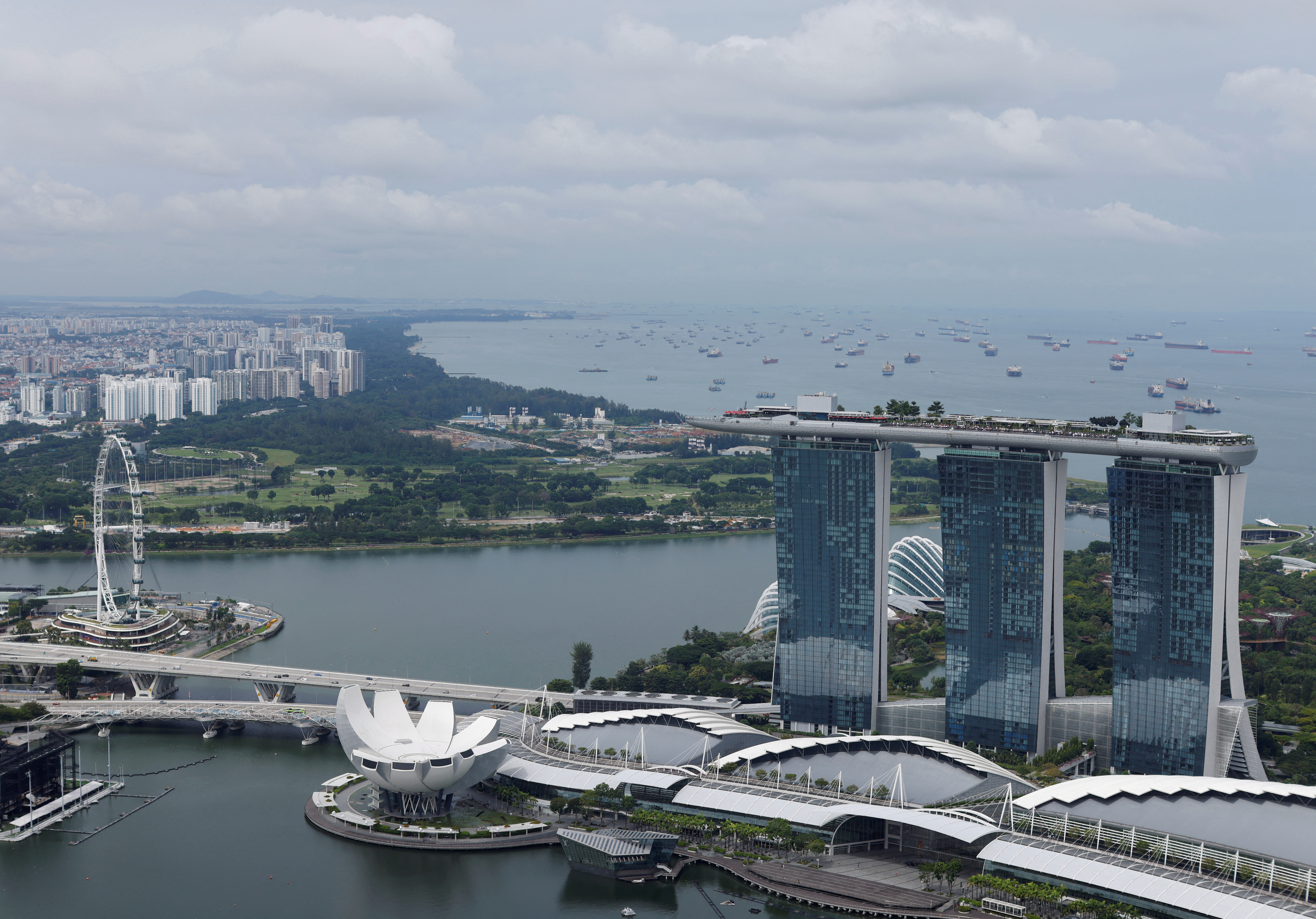 A view of the vessels anchored in the eastern anchorage area, seen behind the Marina Bay Sands integrated resort in Singapore