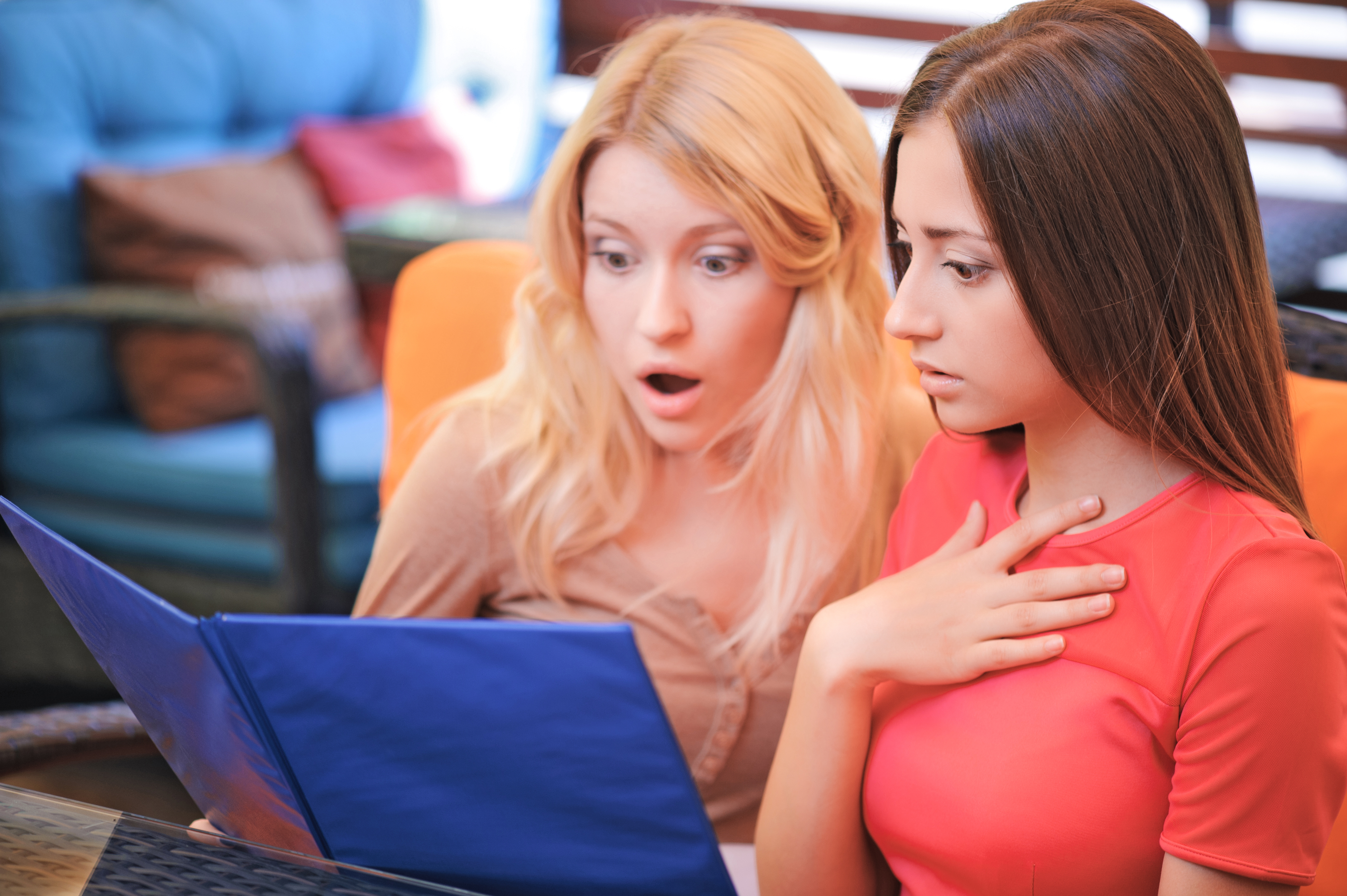Shocking,Prices.,Two,Pretty,Girlfriends,Sitting,In,Cafe,And,Shocked