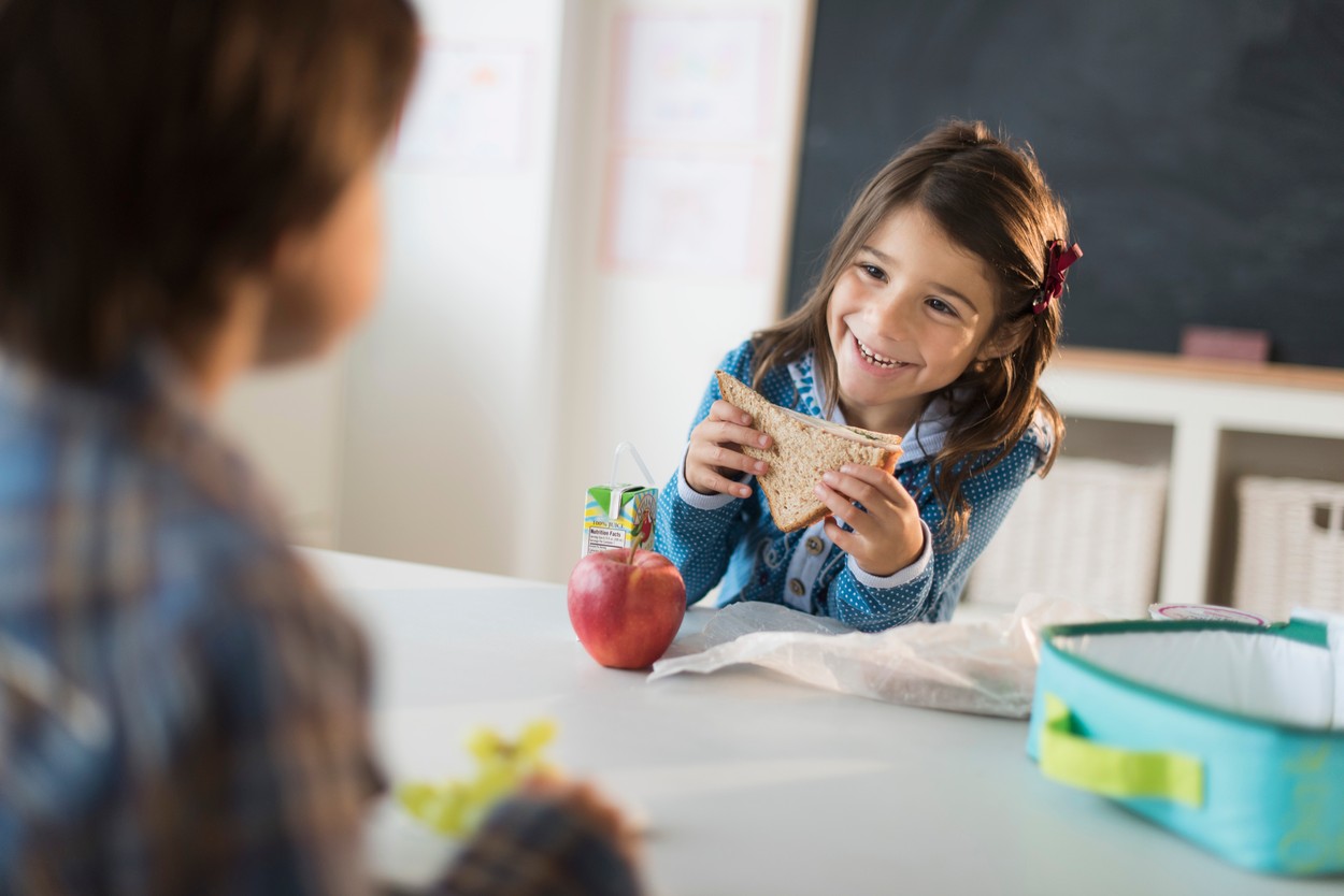 Pupils (6-7) eating lunch in classroom