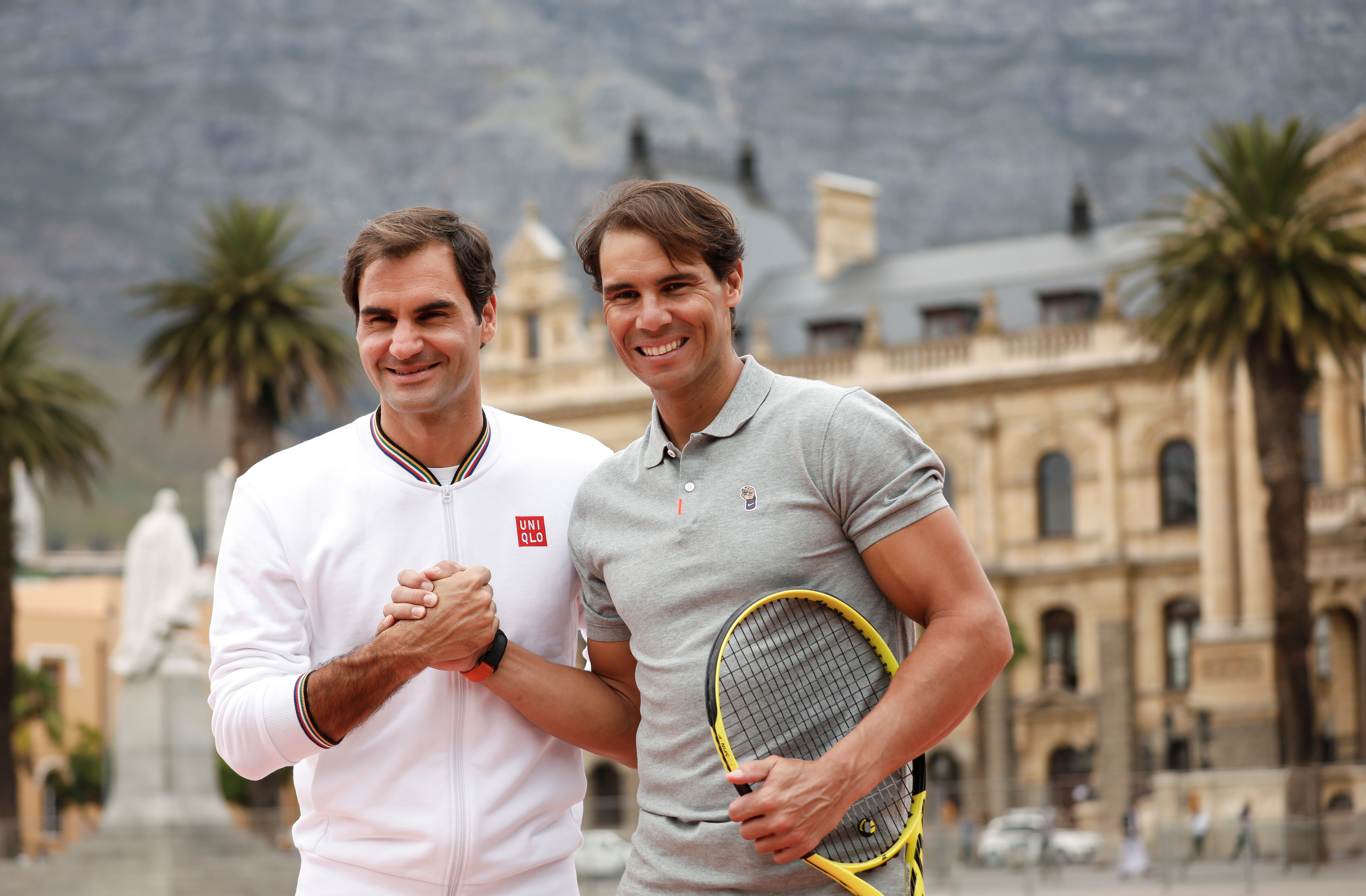 Roger Federer and Rafael Nadal pose for photographers ahead of their "Match in Africa" exhibition tennis match in Cape Town