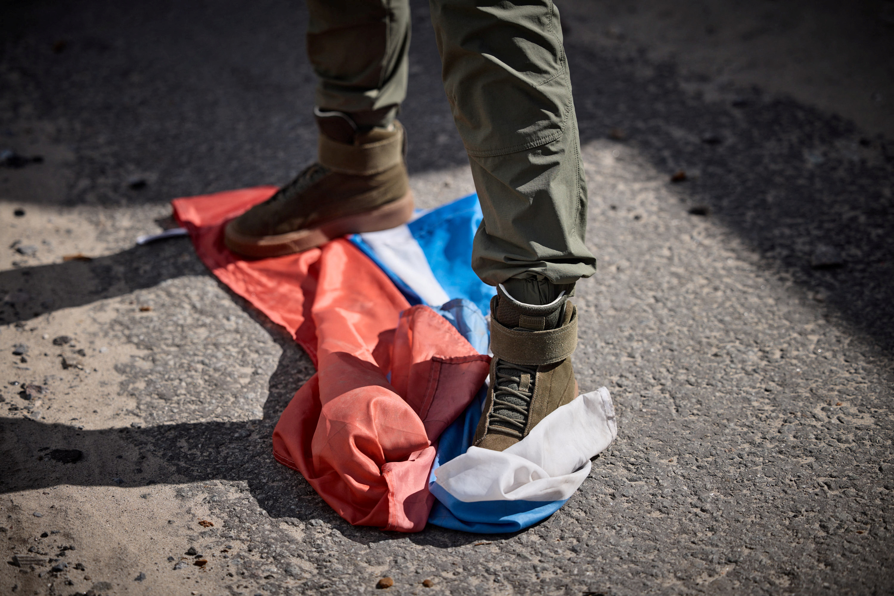 Man stands on Russian flag in the recently liberated town of Kupiansk