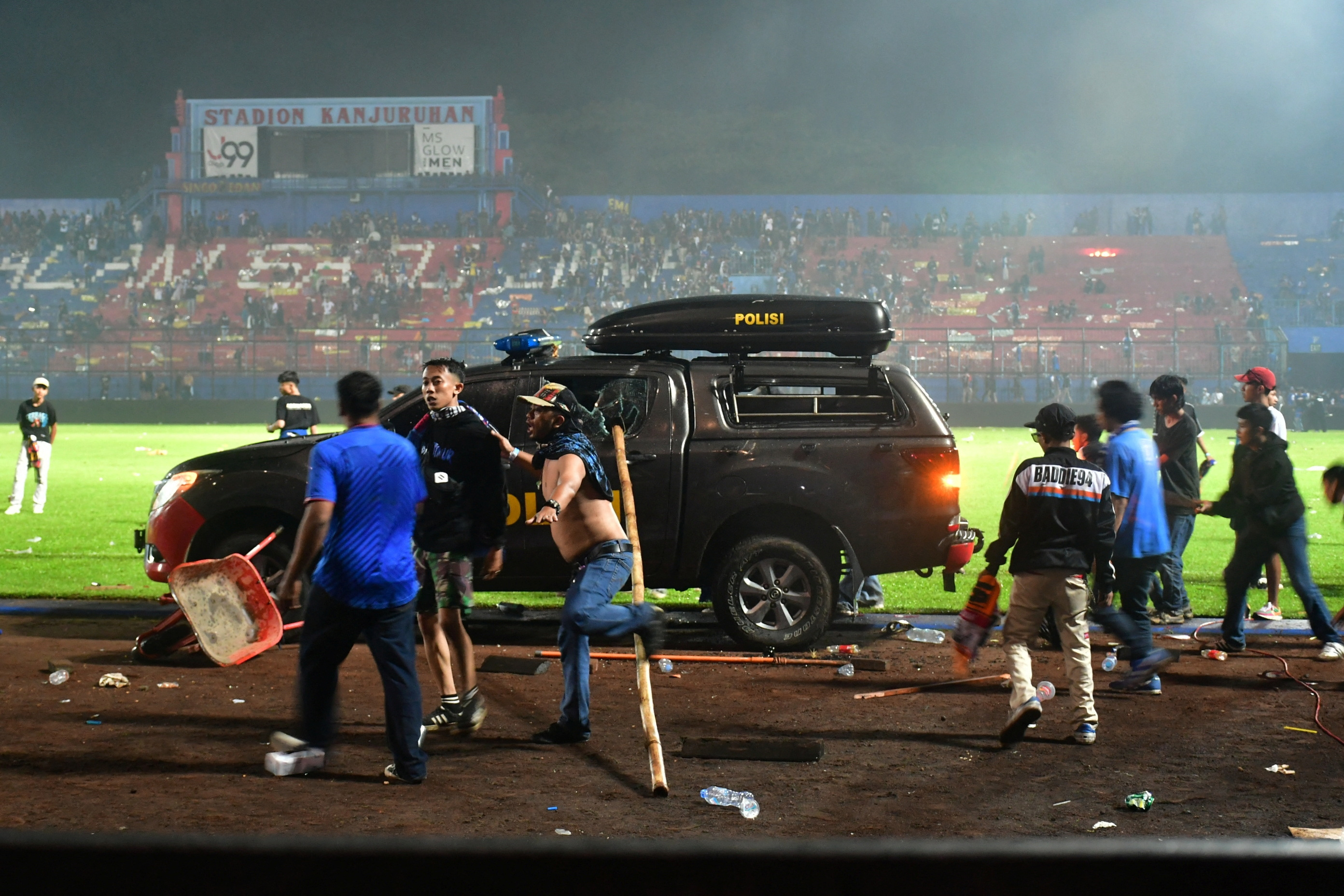 Supporters enter the field during the riot after the football match between Arema vs Persebaya at Kanjuruhan Stadium