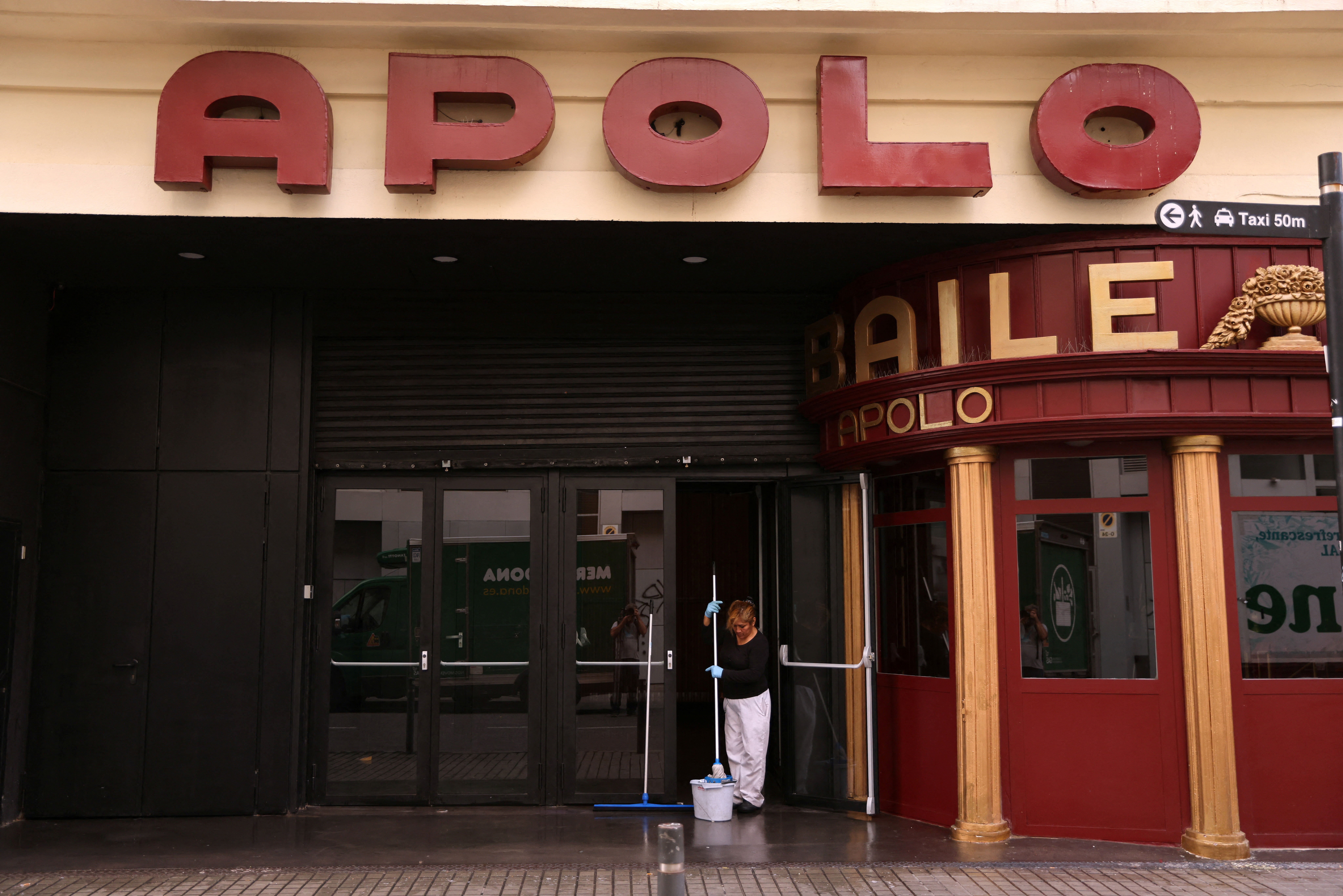 A cleaner is seen outside Apolo, a Barcelona concert hall and night club. Staff from the Apolo found the body of a young man on Wednesday whom the police identified as Australian rugby player Liam Hampson