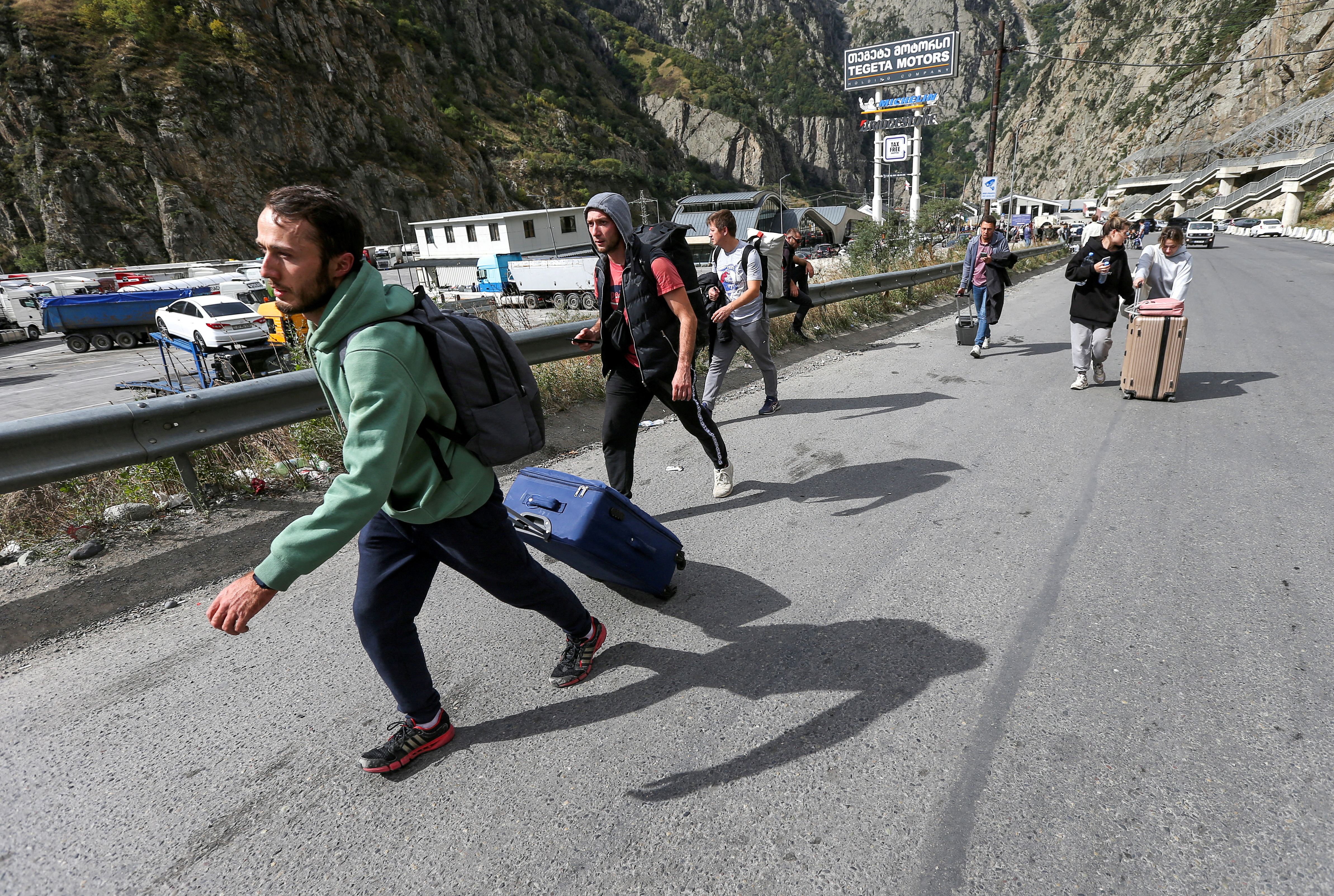 FILE PHOTO: People cross border at Zemo Larsi checkpoint while leaving Russia