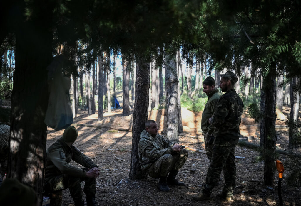 Ukrainian servicemen rest at their position at a frontline in Kharkiv region