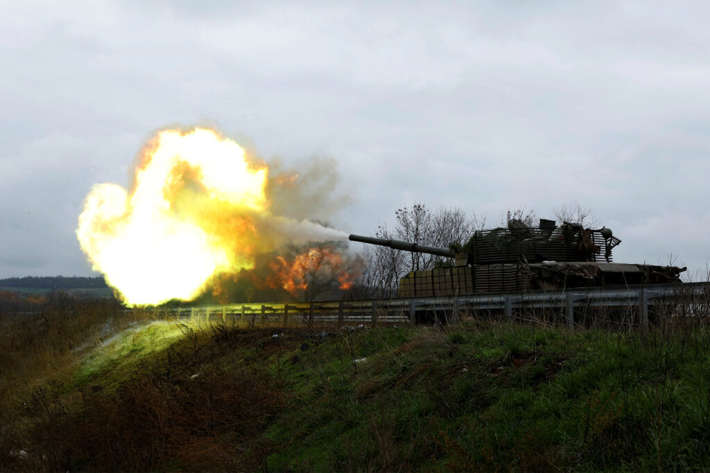 Ukrainian soldiers fires a round from a former Russian tank, in Bakhmut