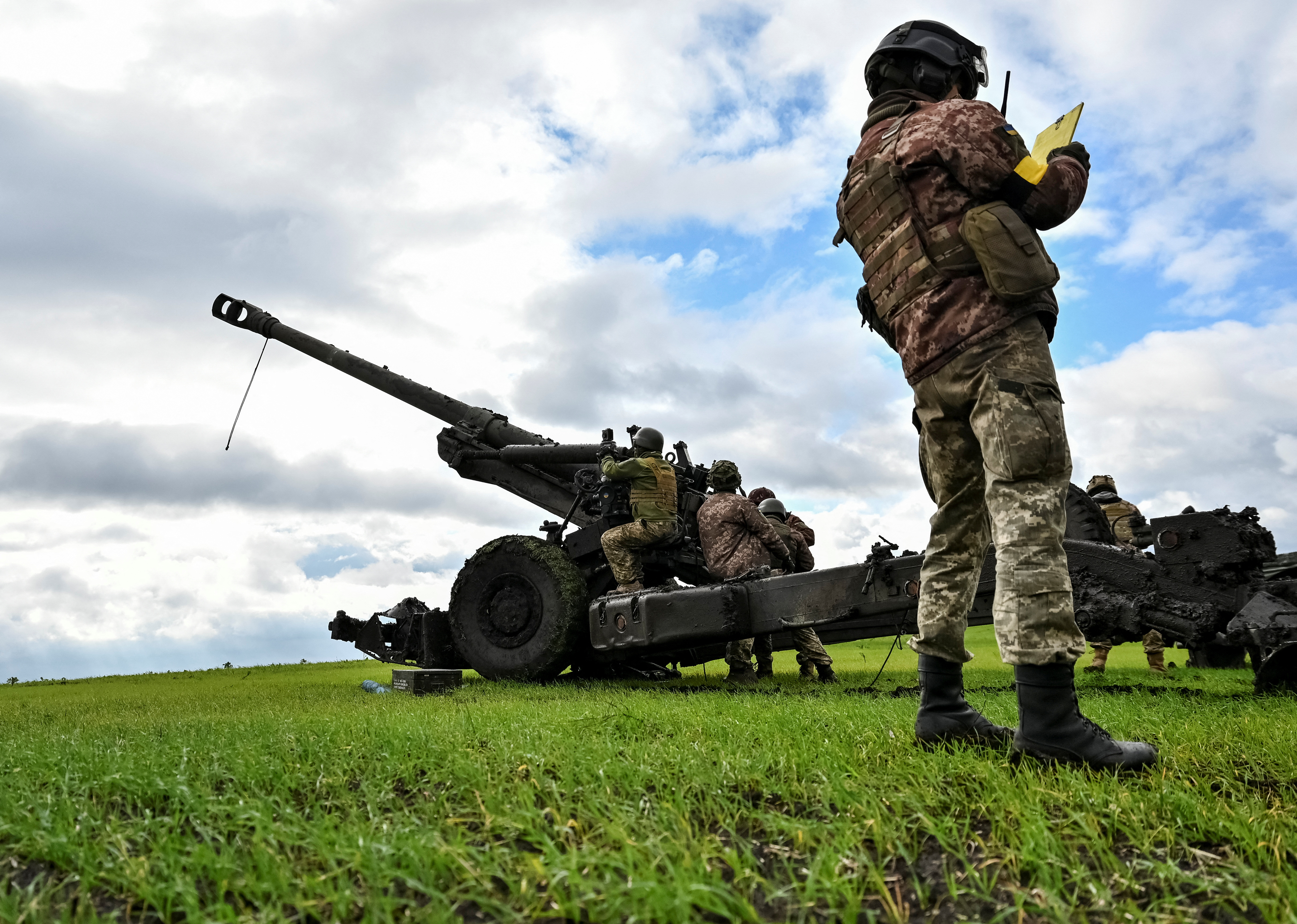 Ukrainian service members prepare to shoot from a towed howitzer at a front line in Zaporizhzhia Region