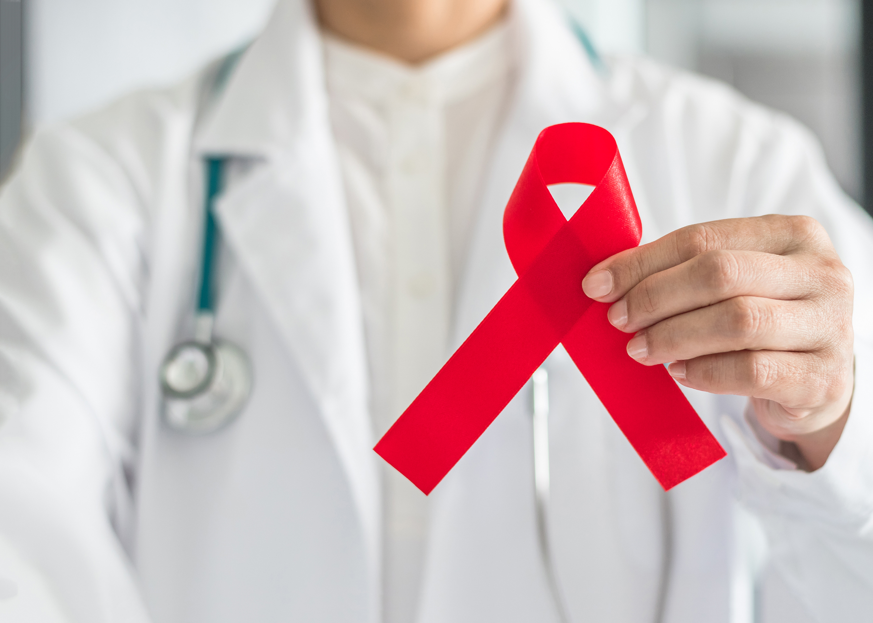 Aids,Red,Ribbon,In,Doctor's,Hand,For,World,Aids,Day