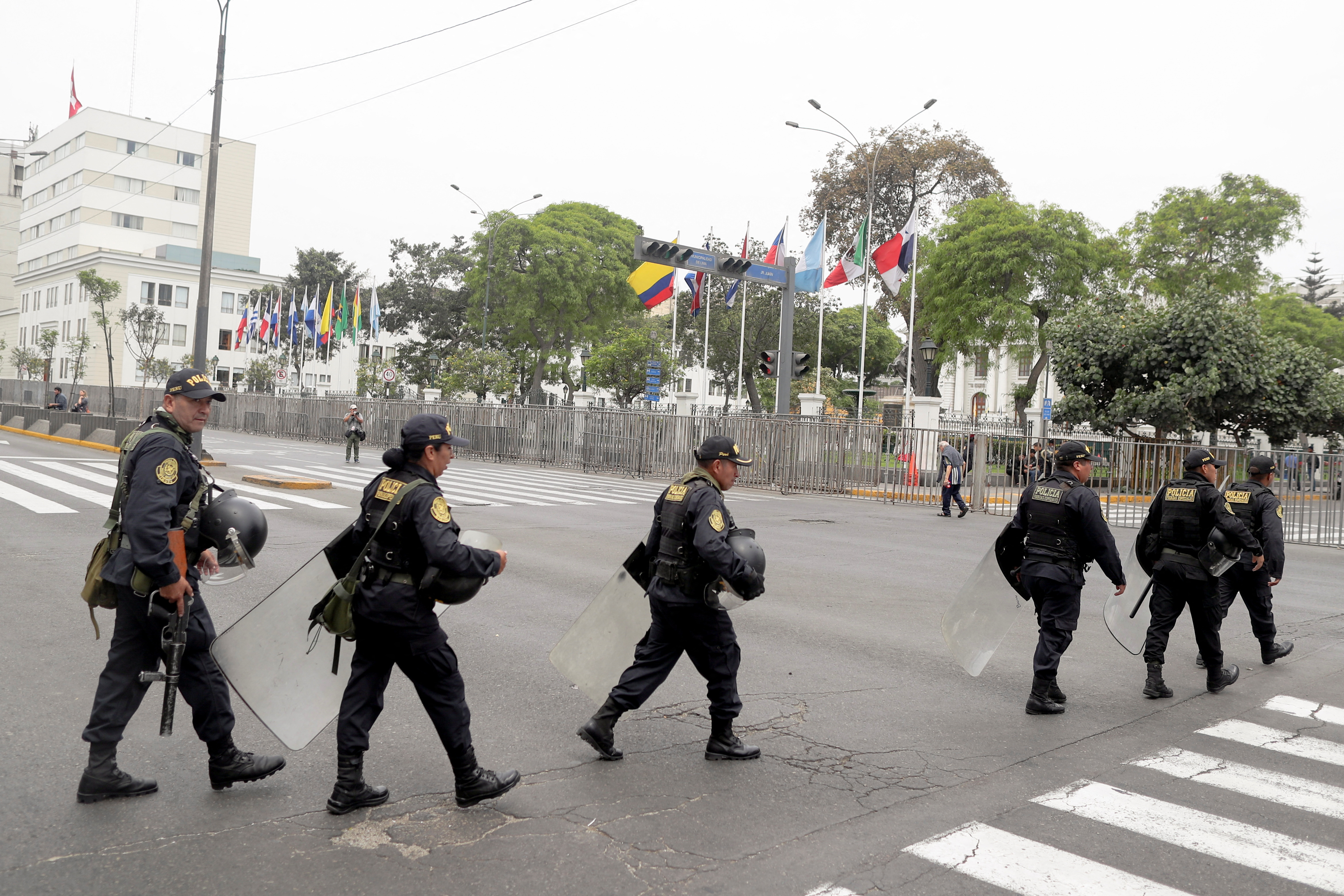Police officers walk outside Peru's Congress in Lima