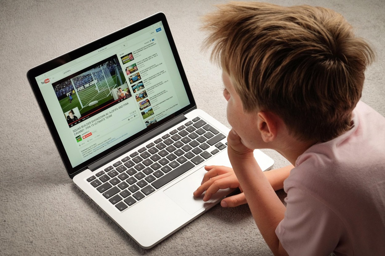 A Child watching Youtube videos on a laptop computer