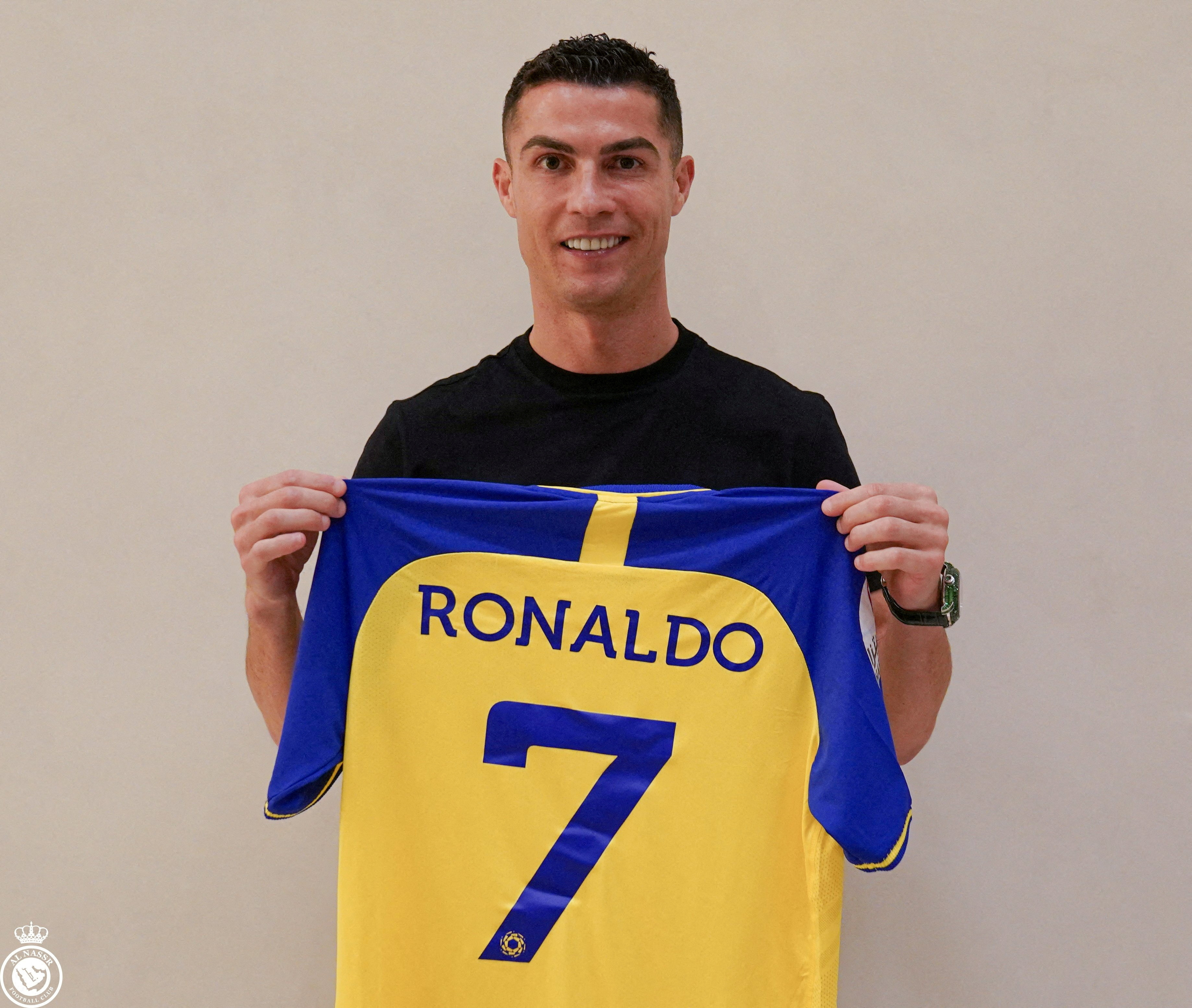 Portuguese soccer player Cristiano Ronaldo holds a shirt of the Saudi club Al-Nassr after signing the contract