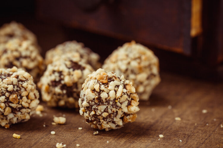 Homemade,Truffles,With,Hazelnut,On,Dark,Wooden,Background