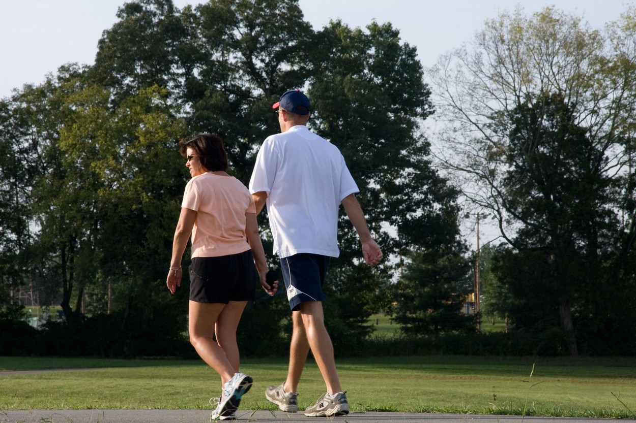 A couple exercise walking in the park