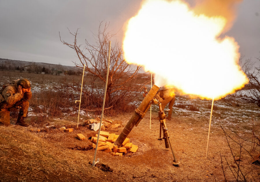 Ukrainian servicemen fire a mortar toward Russian positions on a frontline near the town of Soledar