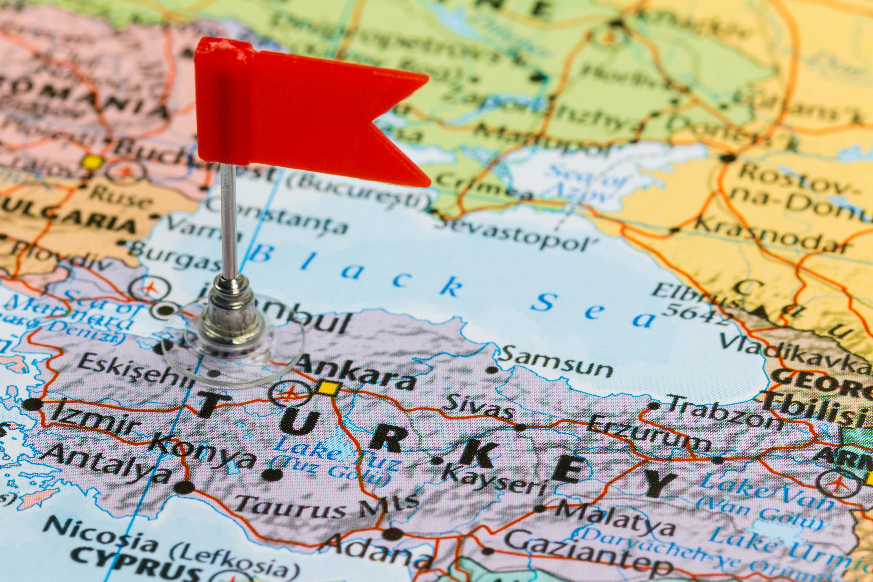 Photo of Turkey marked by red flag in holder. Country on European and Asian continent.