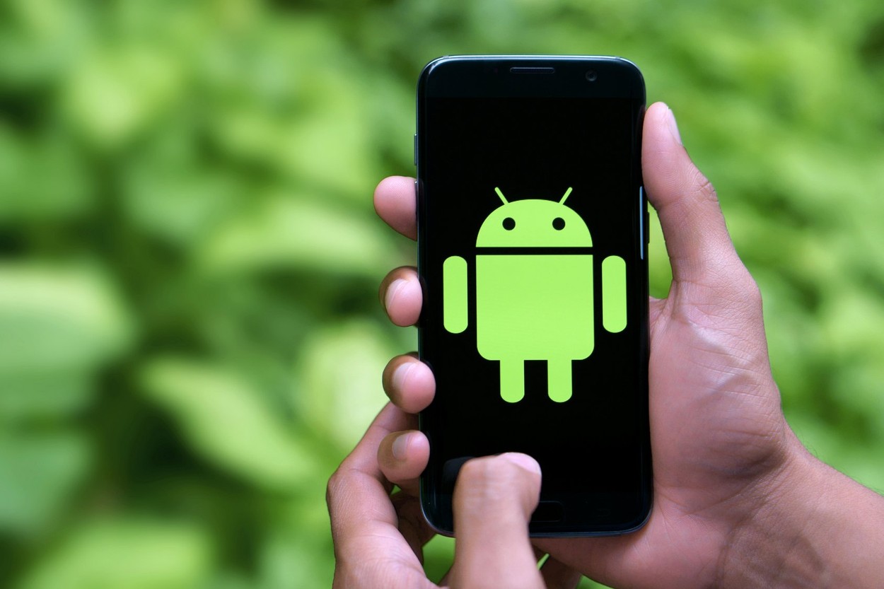 Man holding android mobile with logo