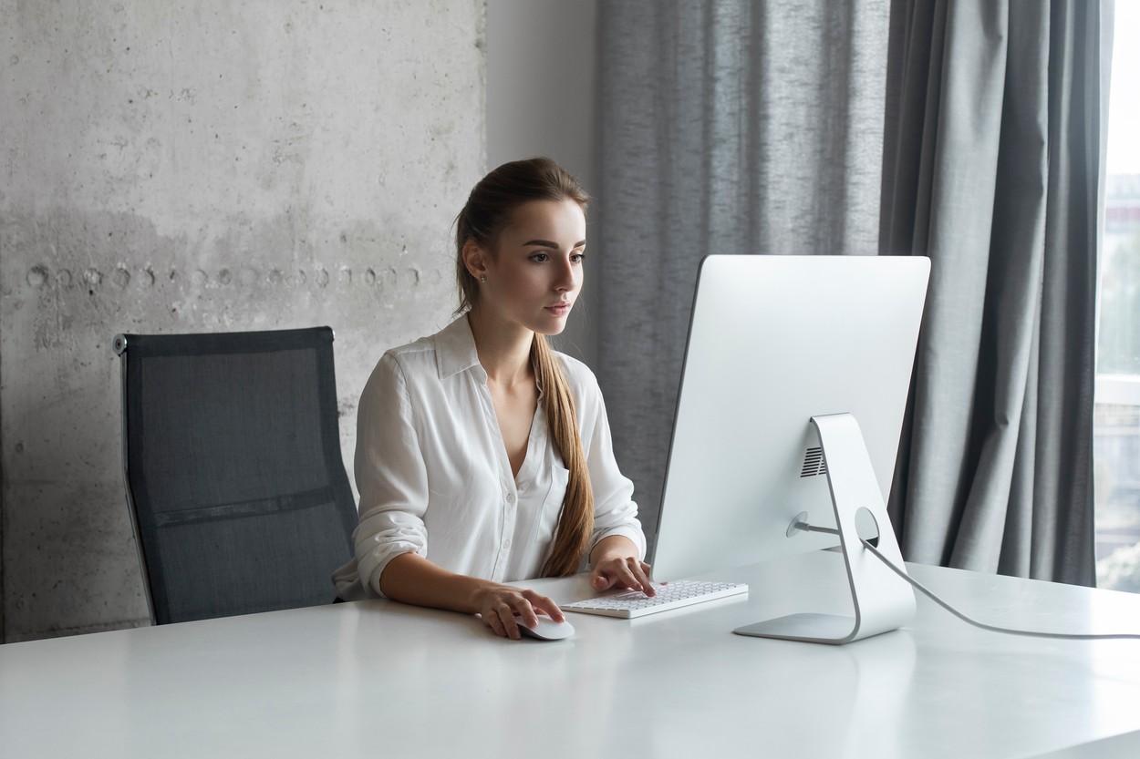Young businesswoman working on desktop computer