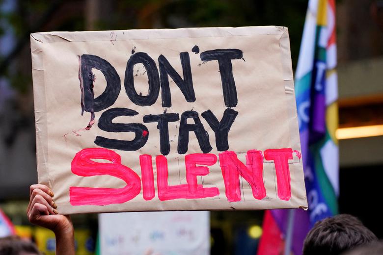 Učesnica drži plakat na demonstracijama povodom Međunarodnog dana žena u Melburnu, Australija, 8. marta 2023. REUTERS/Sandra Sanders