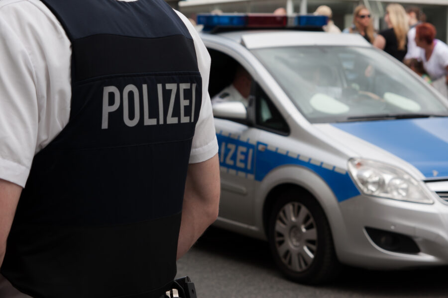 German,Police,Officer,In,Front,Of,A,Crowd