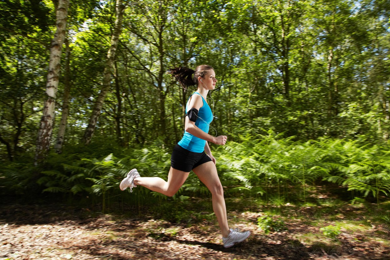 Woman running in forest