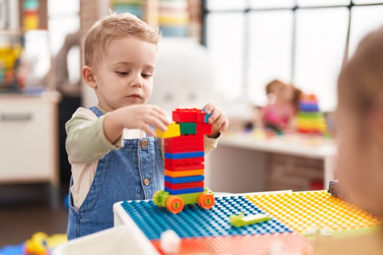 Adorable,Toddler,Playing,With,Construction,Blocks,Standing,At,Kindergarten
