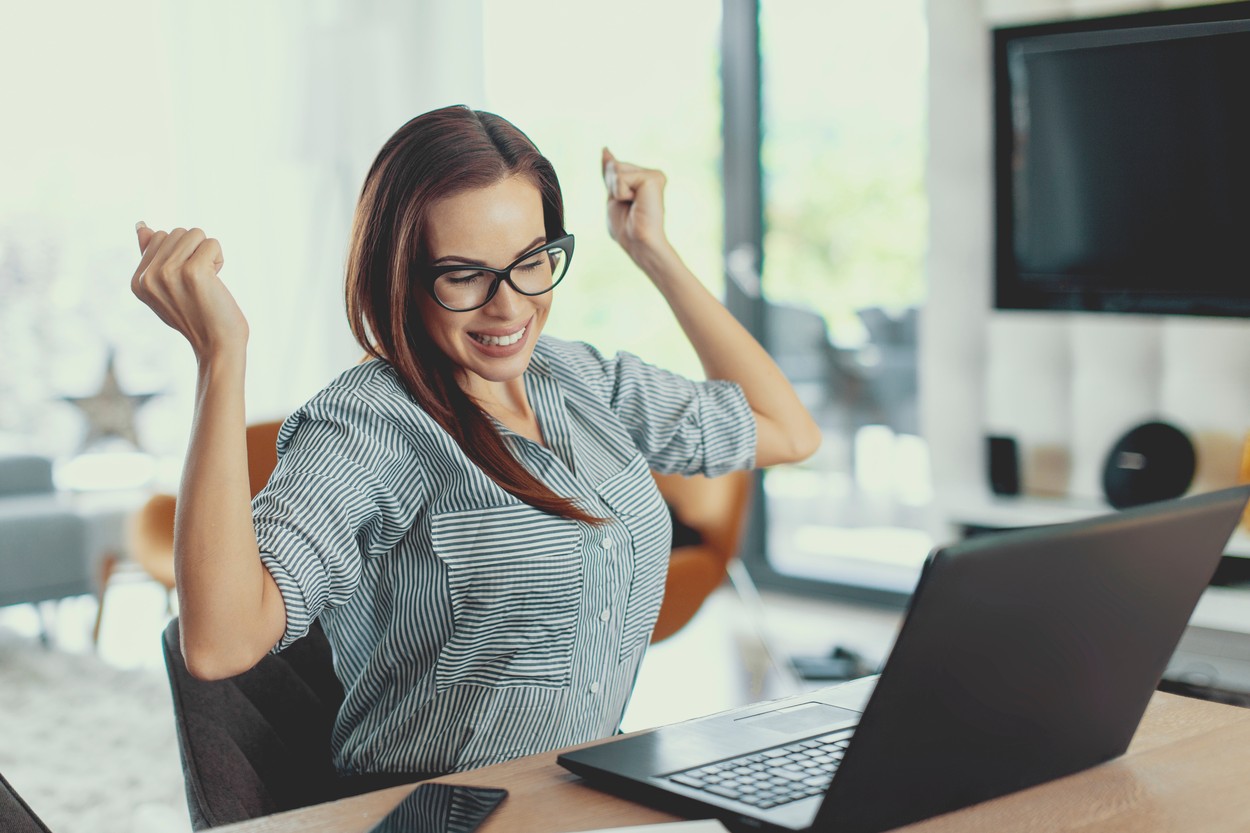 Happy woman using laptop
