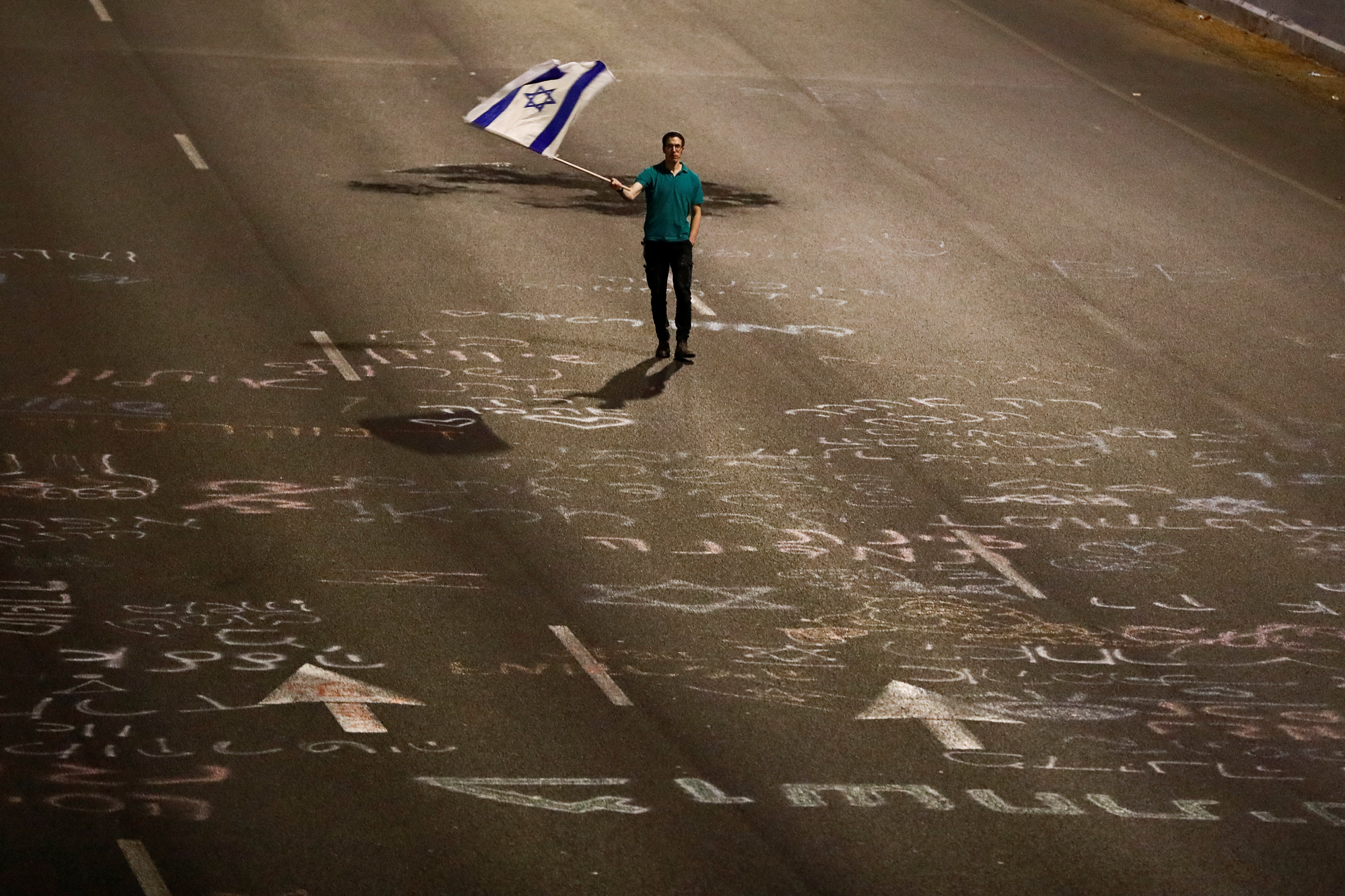 Israeli protestors attend a right-wing demonstration in support of Israel's nationalist coalition government and its judicial overhaul, in Tel Aviv