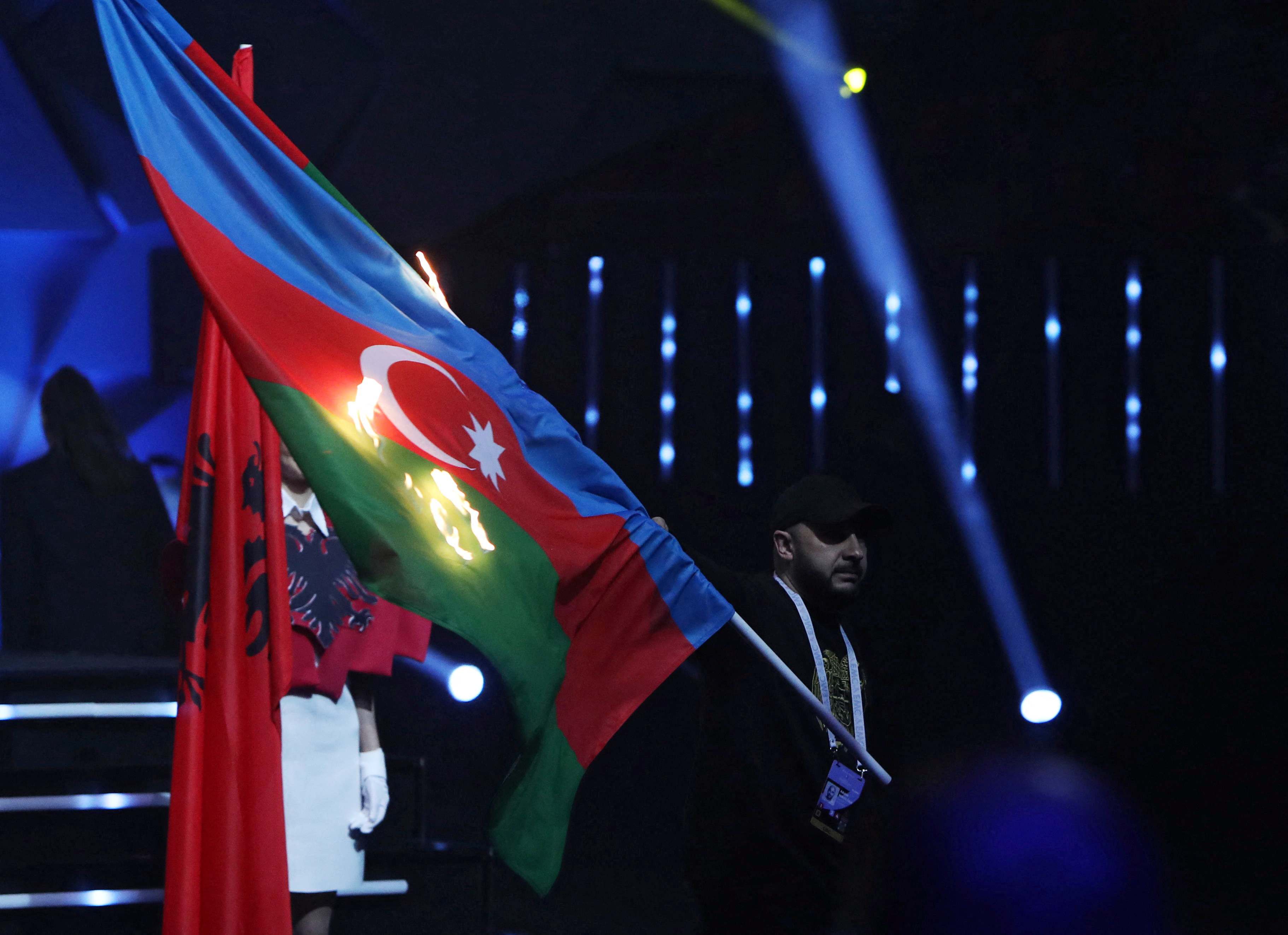 A man sets fire to the flag of Azerbaijan during the opening ceremony of the European Weightlifting Championships in Yerevan