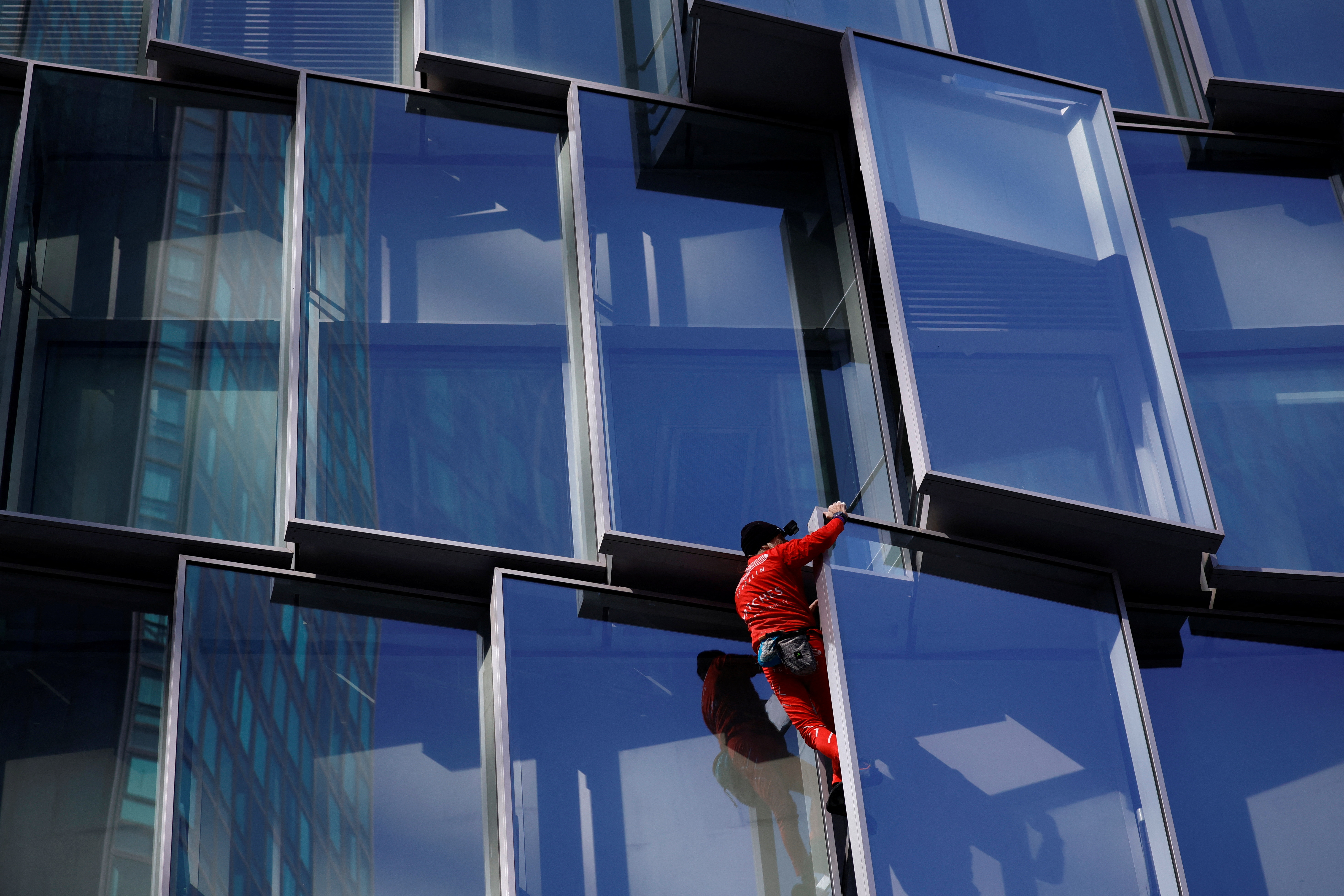 French "Spiderman" Alain Robert scales a skyscraper "for the people" in Paris