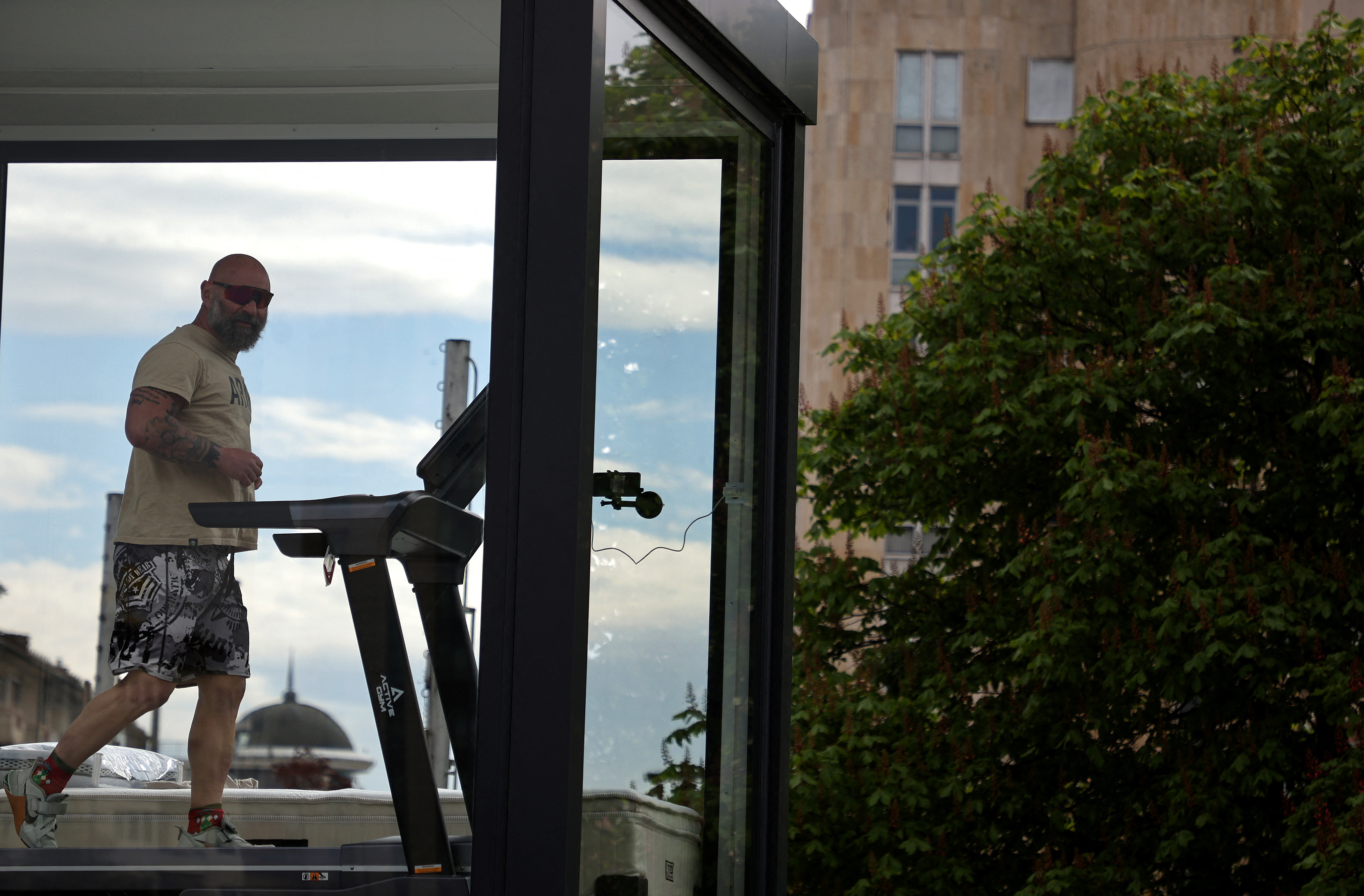 Bulgarian ultramarathon runner self-isolates in a glass cage as part of a social experiment aimed to raise donations, in Sofia