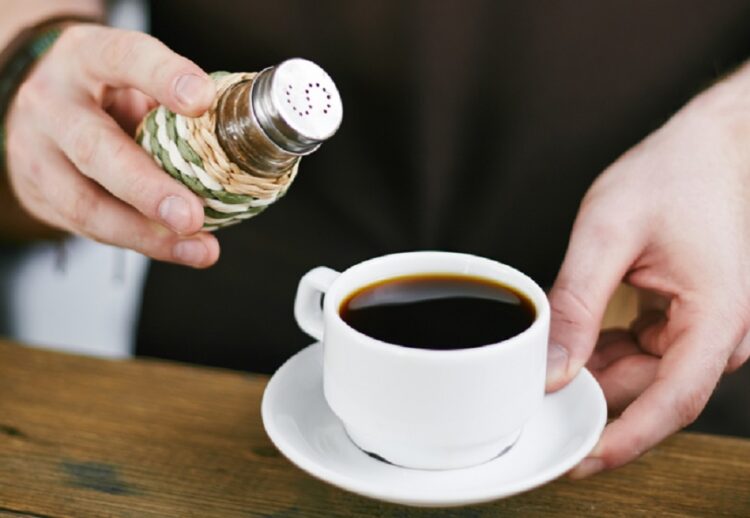 Hands,Of,Barista,Adding,Salt,In,Black,Coffee
