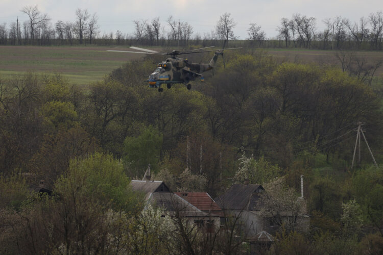 Ukrainian military helicopter flies over a village in Donetsk region