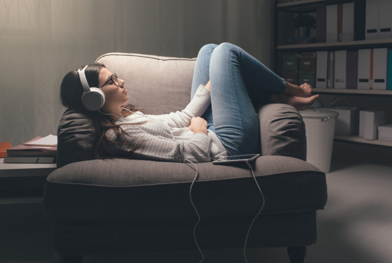 Young,Woman,With,Headphones,Relaxing,At,Home,Late,At,Night,
