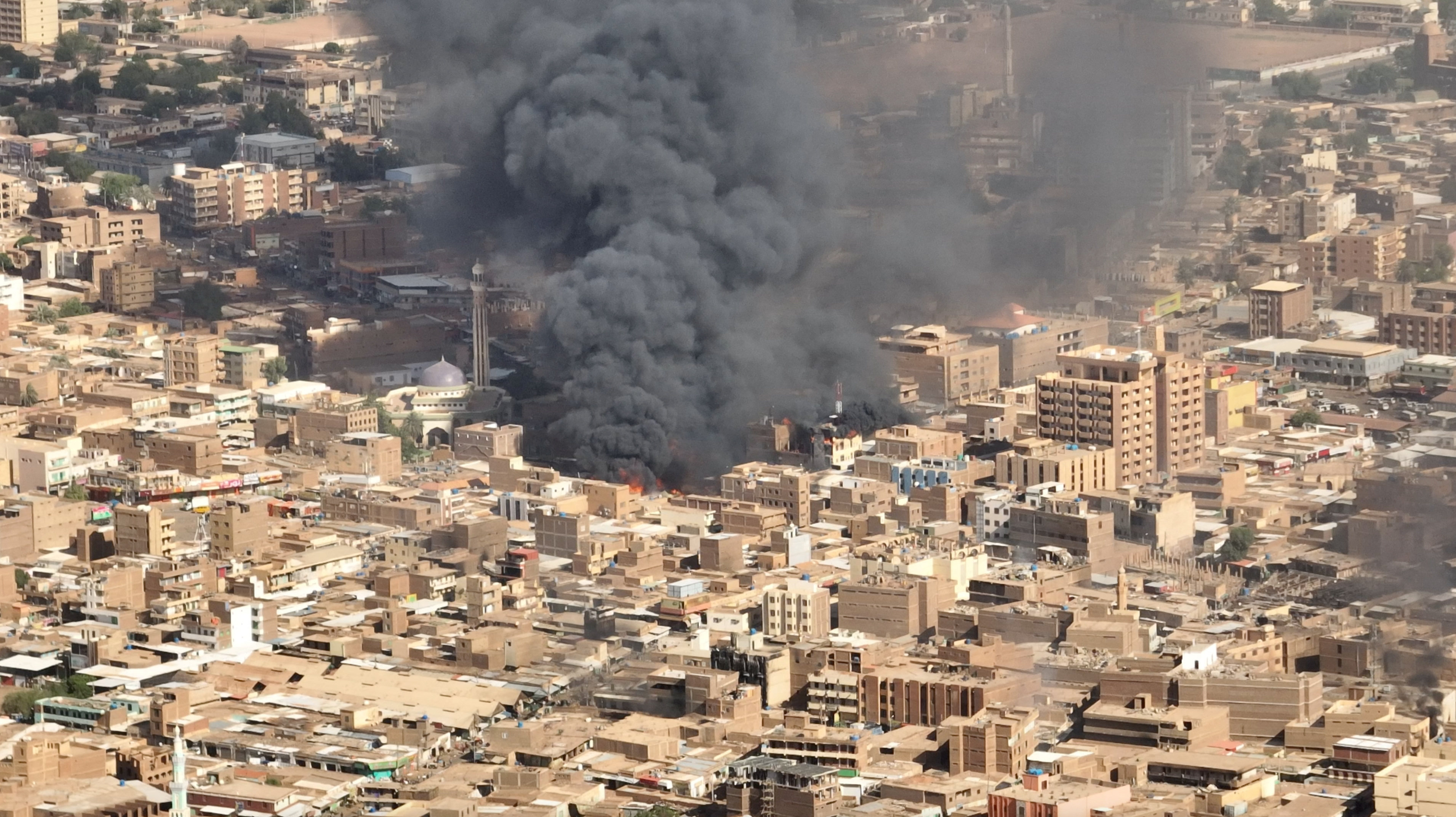 An aerial view of black smoke and fire at Omdurman market