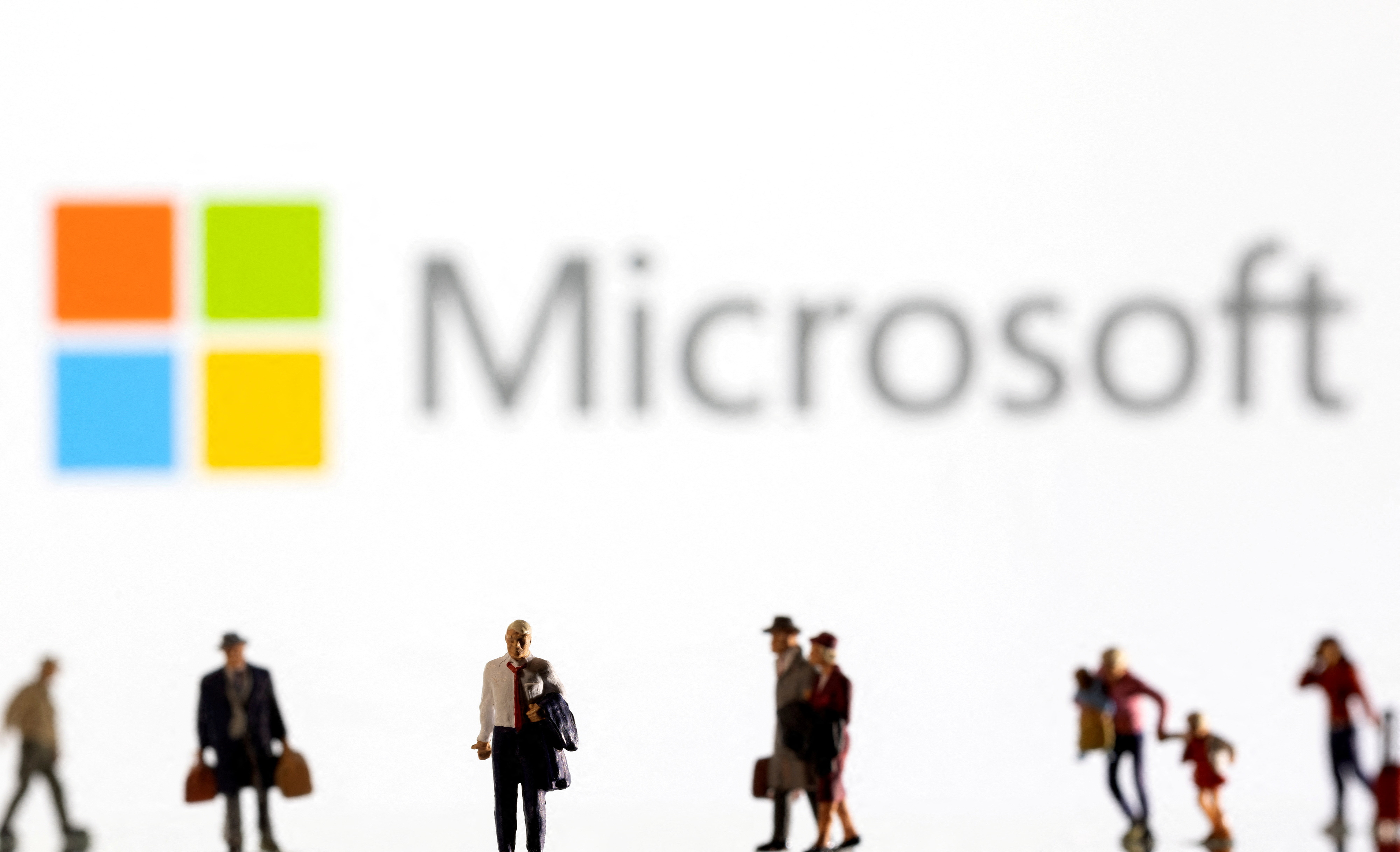 FILE PHOTO: Illustration shows small figurines and displayed Microsoft logo
