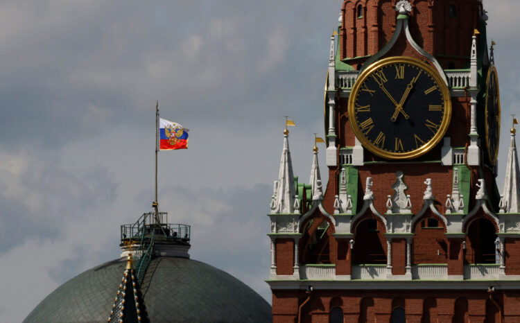The Russian flag flies on the dome of the Kremlin Senate building in Moscow