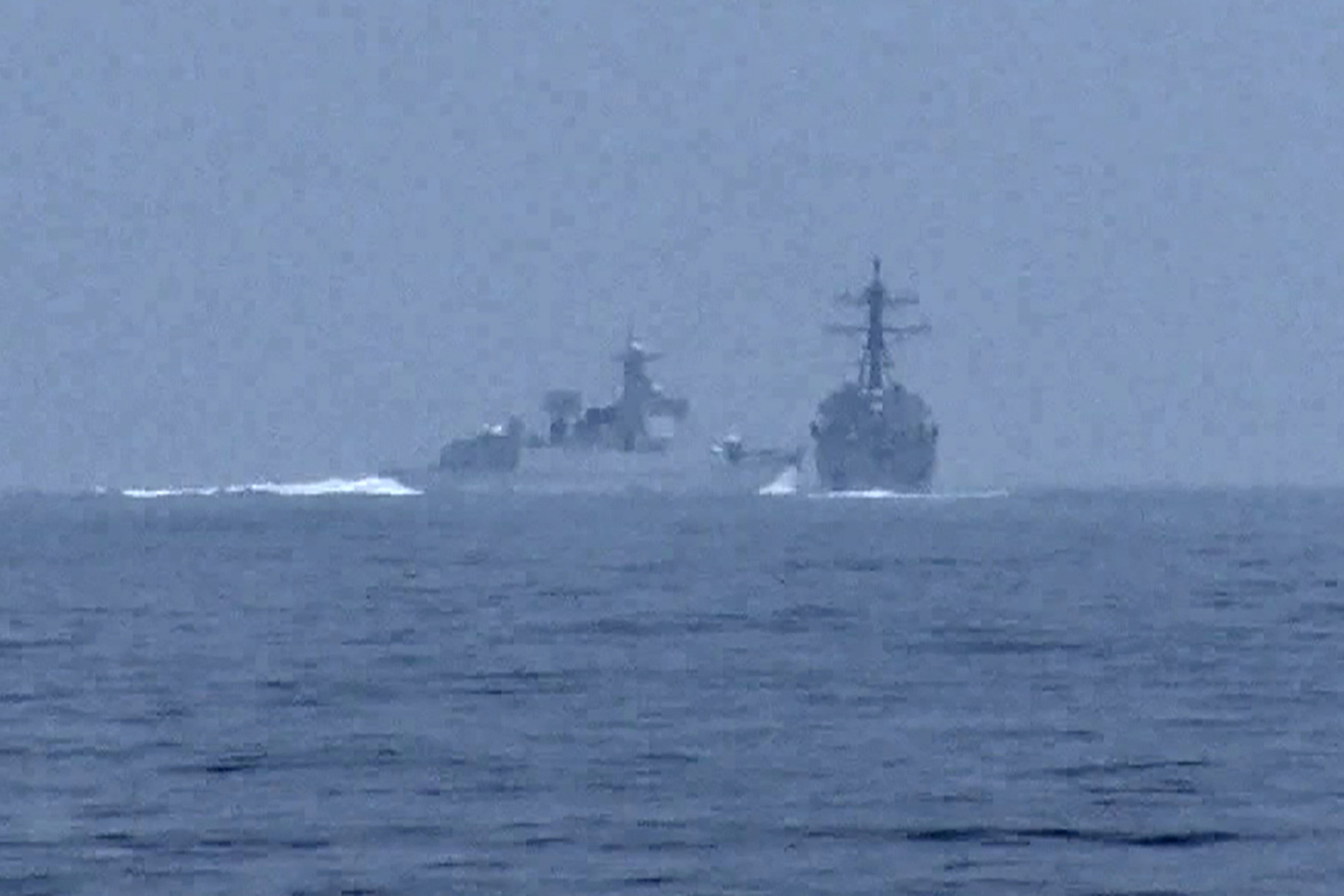 Chinese warship crosses the path of U.S. Navy destroyer USS Chung-Hoon in the Taiwan Strait