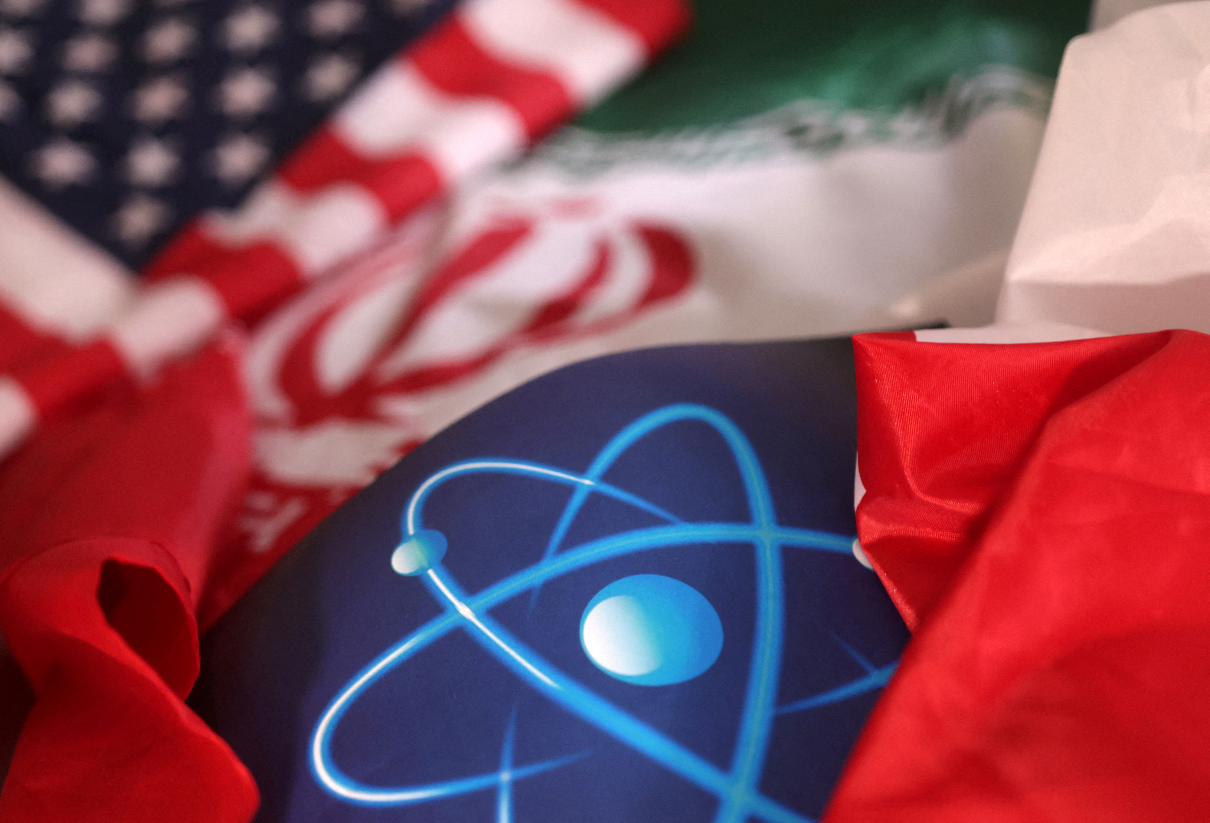 FILE PHOTO: Illustration shows atomic symbol and USA and Iranian flags