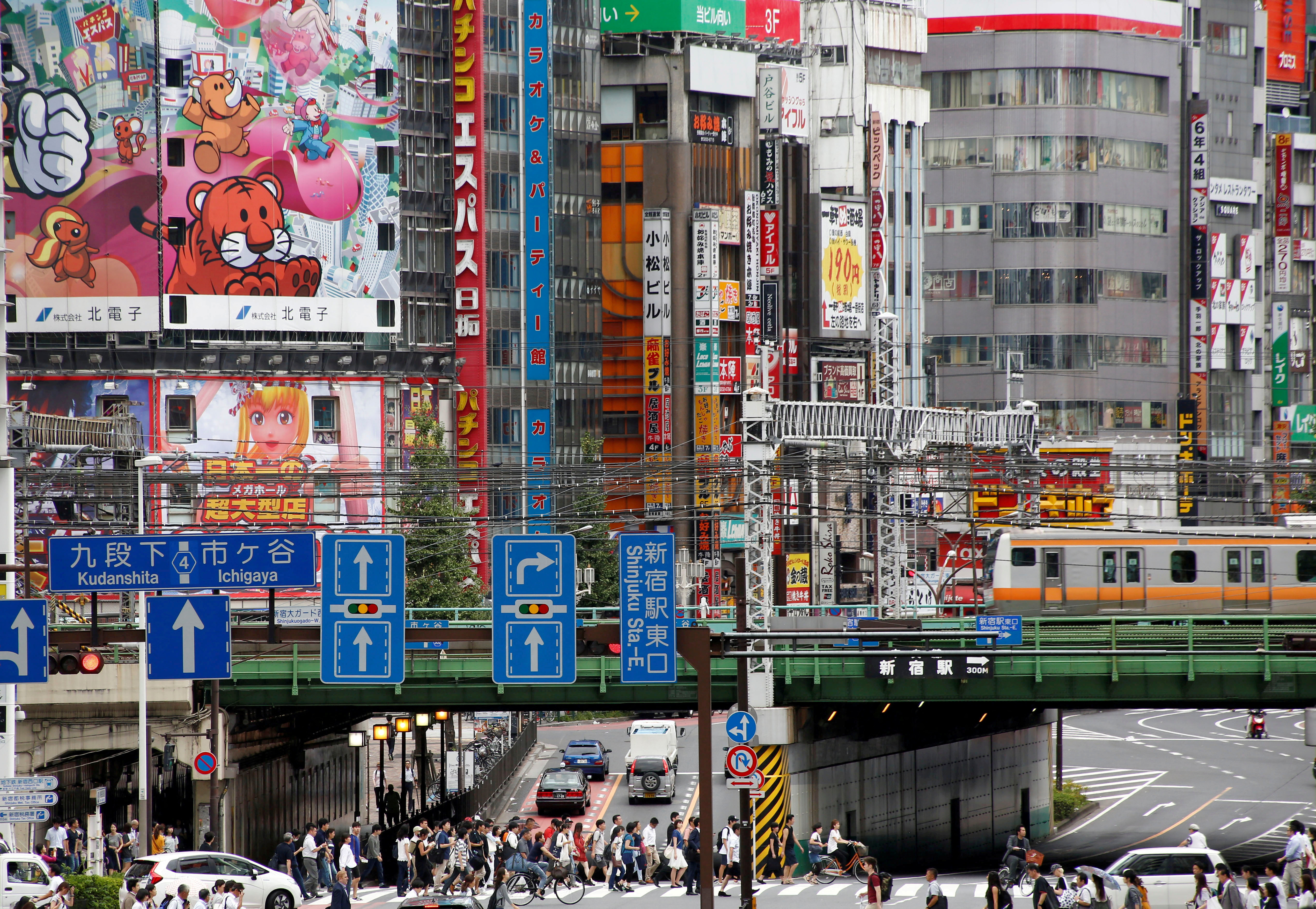 FILE PHOTO: People cross the street  at a shopping district  in Tokyo