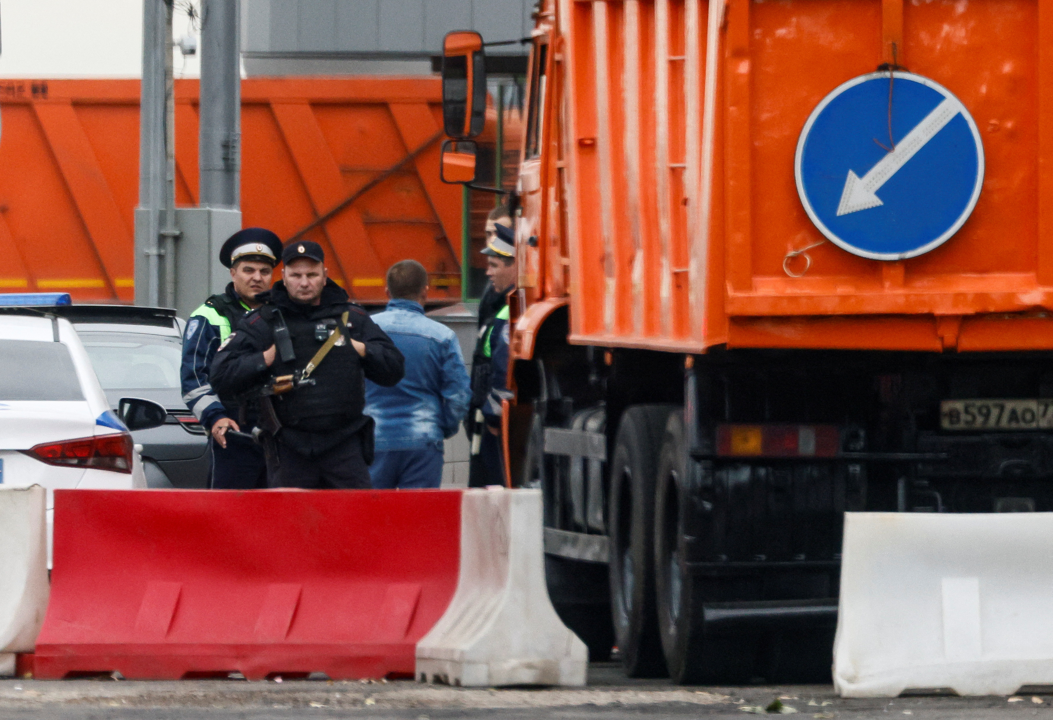 Law enforcement officers watch traffic at a checkpoint in Moscow